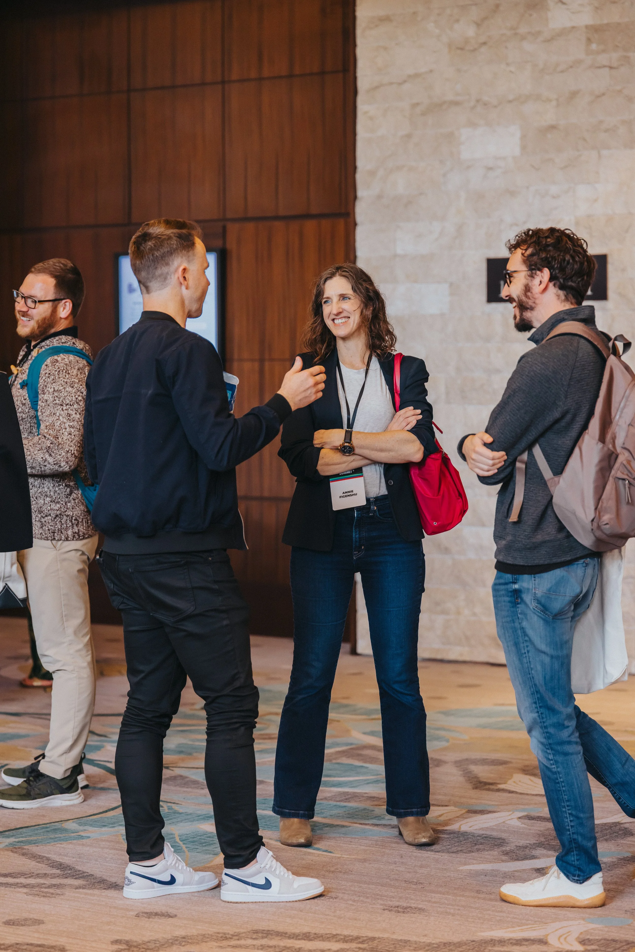 Annie Figenshu talking with fellow StoryBrand Certified Guides at the Coach Builder Summit in 2025.