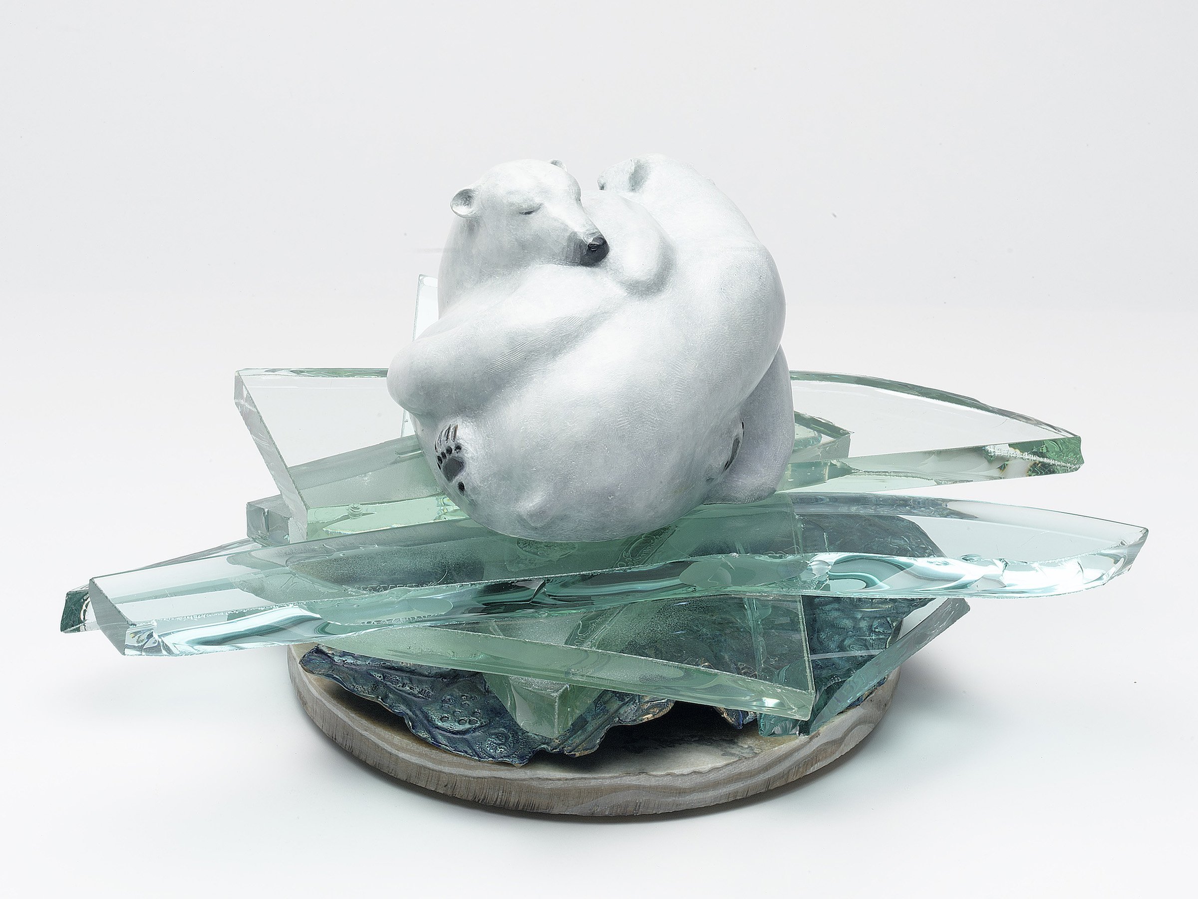 16. GLOBAL WARNING , Sara Mall Johani 2014. Dimensions: with base 12" X 18". Cast bronze with glass & stone. Two Ice Bears huddle together on a drifting, disintegrating ice floe. The Ice Bear - Polar Bear - has become a powerful icon for warm