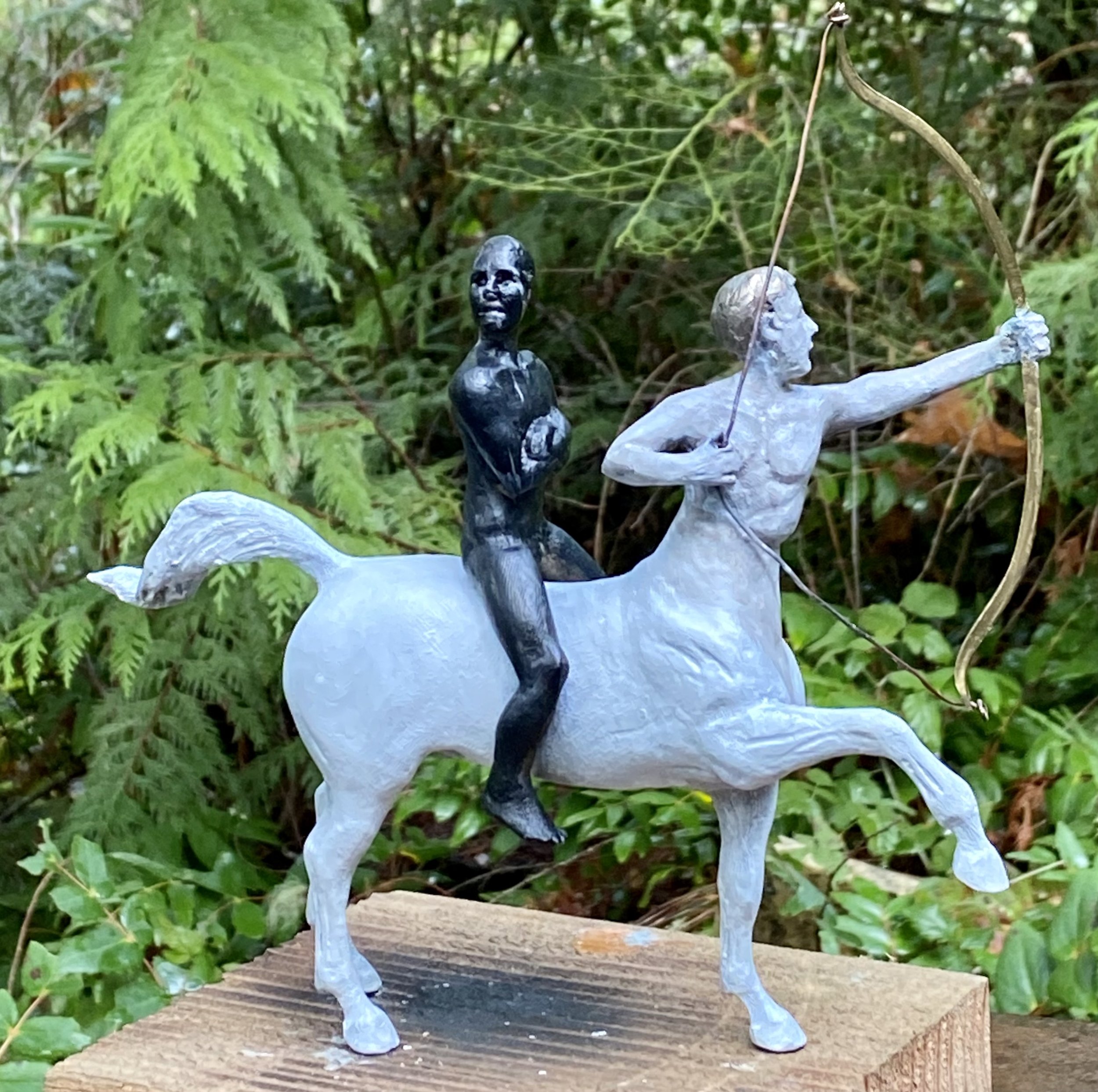 13. INDIVISIBLE , Sara Mall Johani White Centaur with bow and black figure. Exceptionalism. White shooting high, black person is forced to go along. Cast bronze. 10"X3"X9" One of a kind.