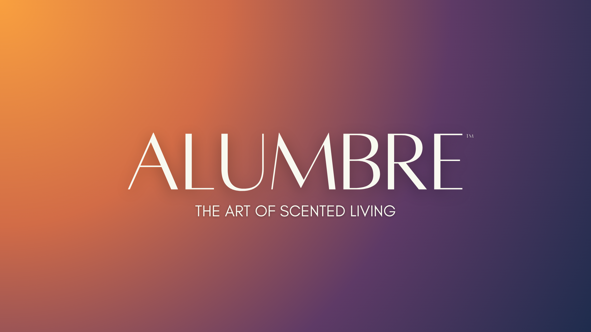 Green candle jar with a label that reads 'ALUMBRE LUX PEREGRINE' surrounded by tropical leaves and a lit white candle on a green surface.