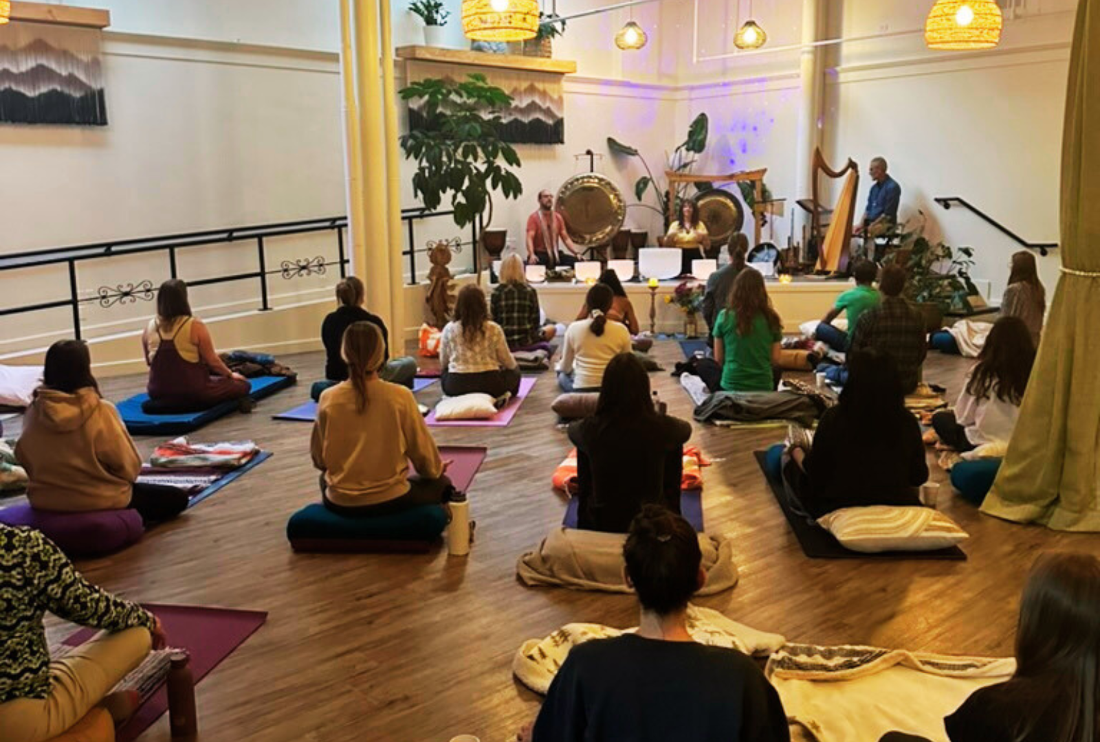 People on mats in a soundbath