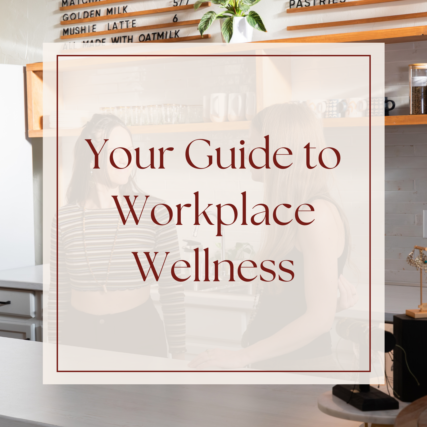 Two women at a cafe smiling behind the counter, with the text overlay "your guide to workplace wellenss"