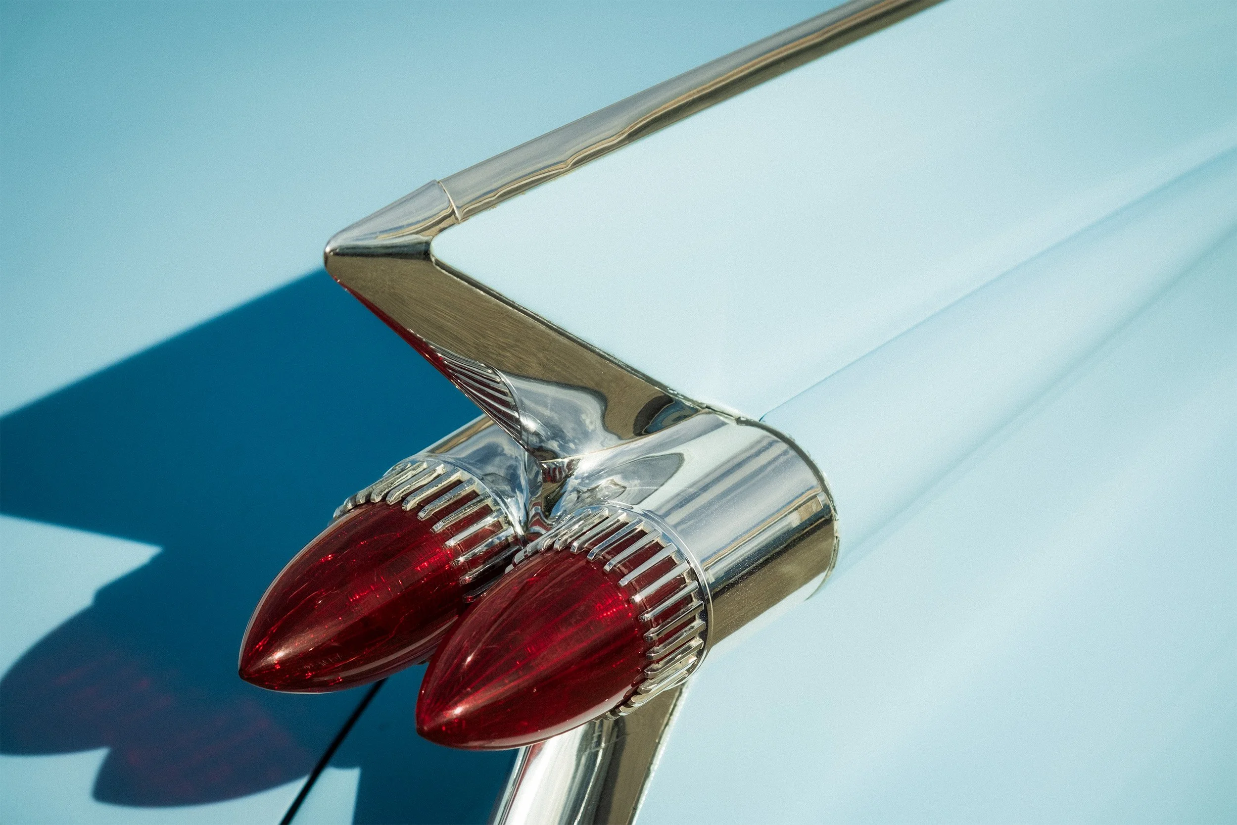Image of a blue 1959 Cadillac Da Ville tail fin