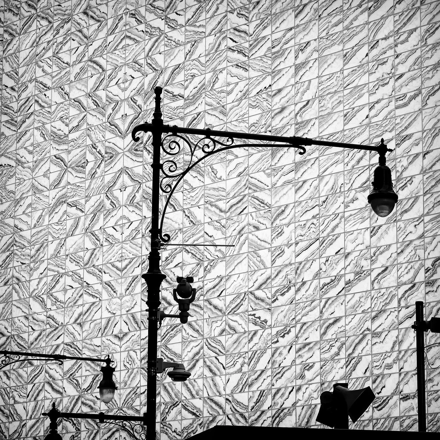 Image of silhouetted street lamps against the Perelman Performing Arts Center, NYC.