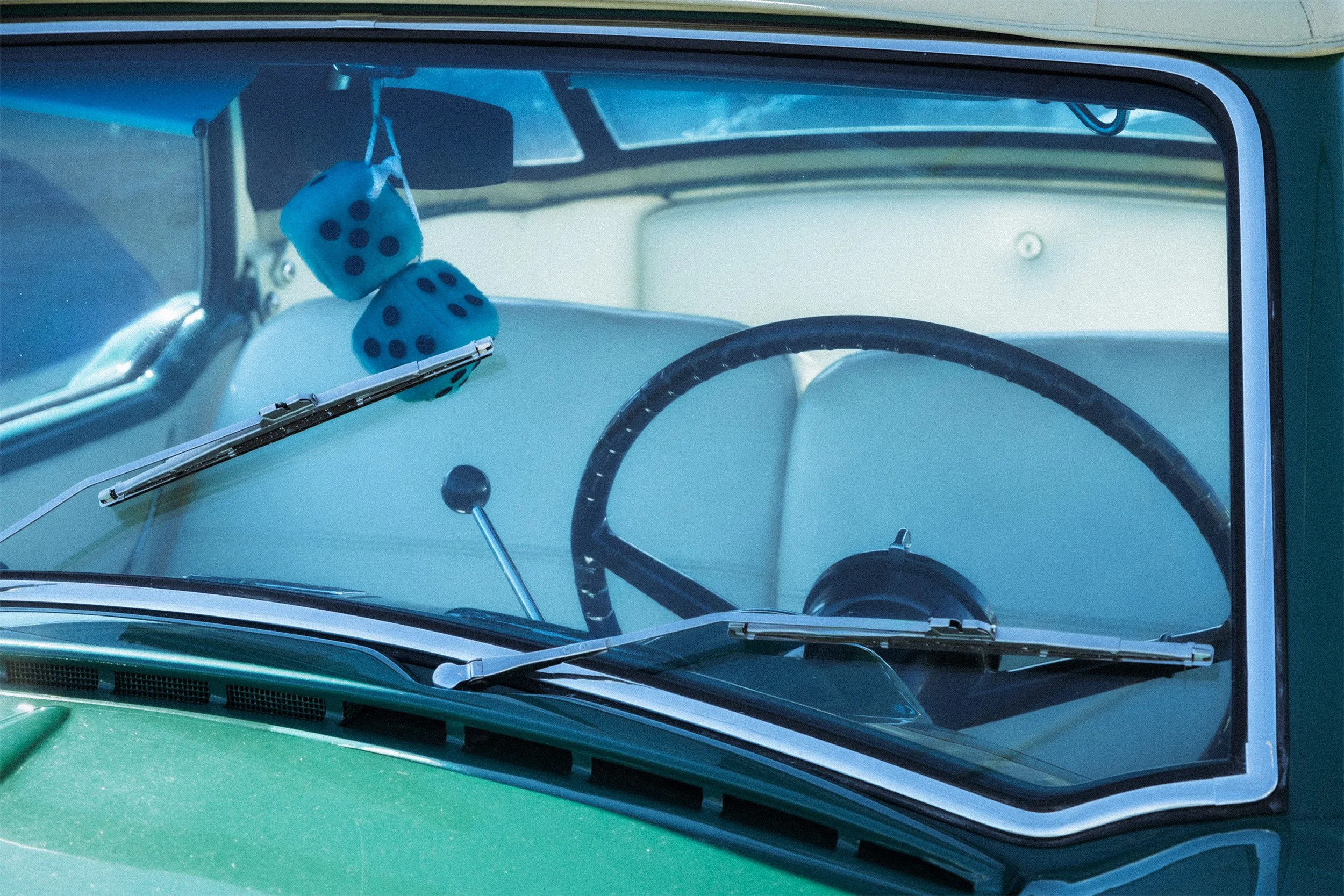 Image of a Nash Metropolitan with green fuzzy dice.
