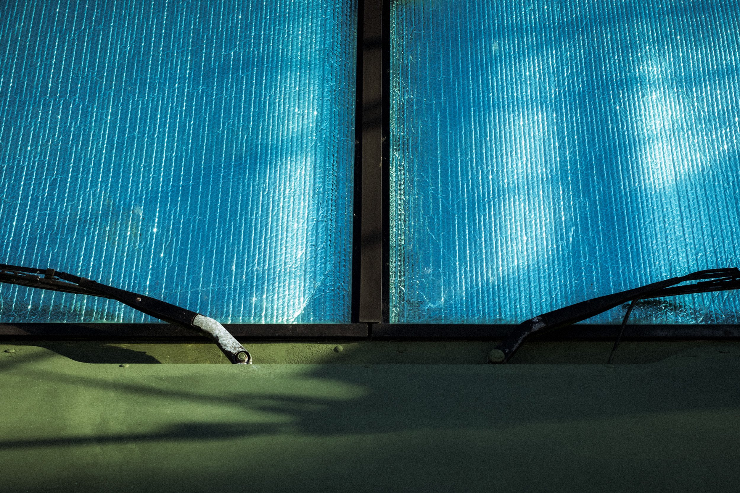Image of bubble wrap in the windows of a green army truck