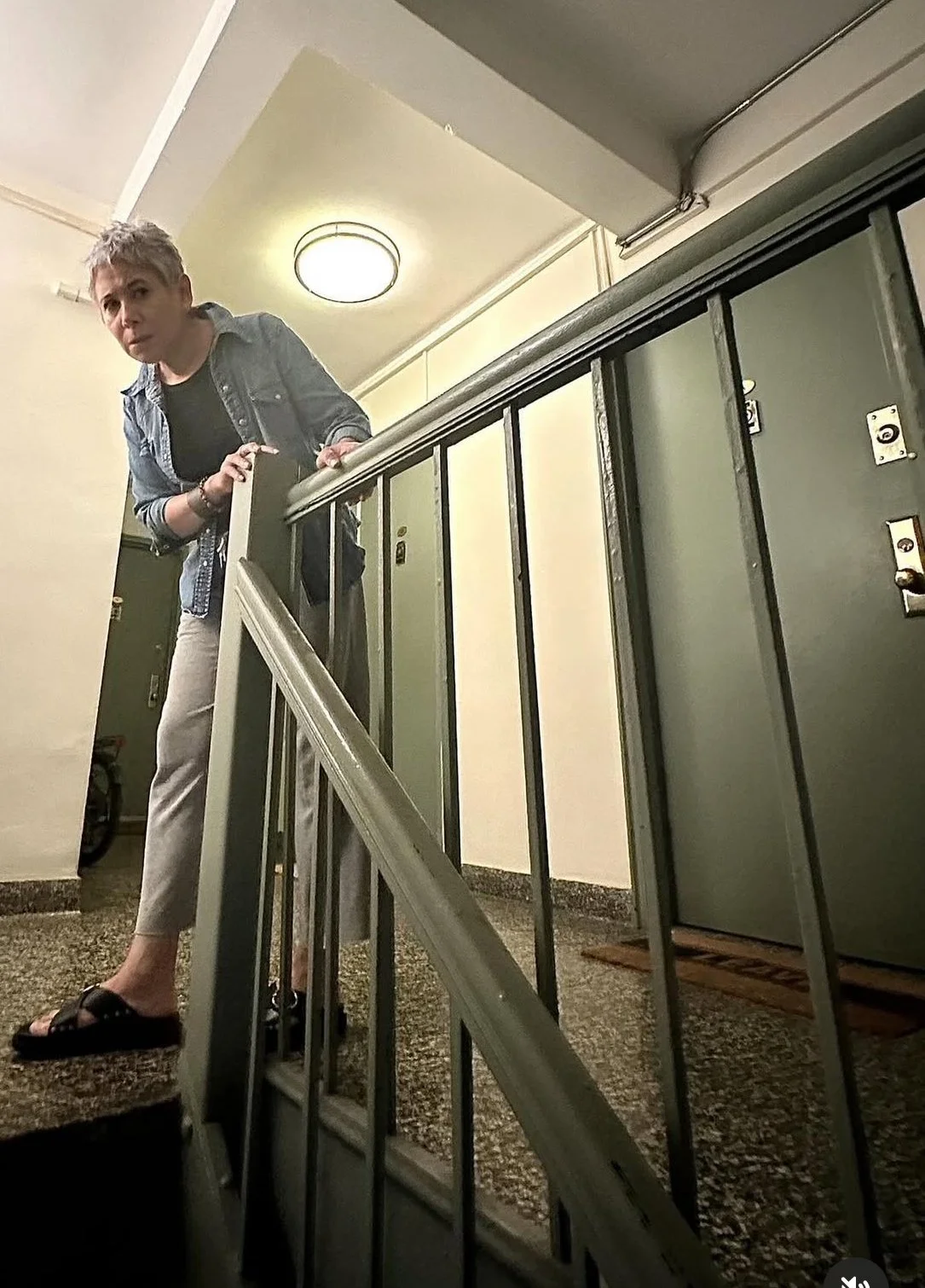 Xena (Gina Jarrin) checks the stairs for intruders.