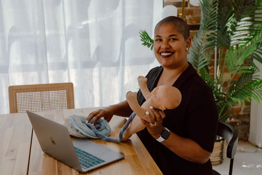 Doula Kelli Blinn in Columbus Ohio teaching labor and delivery class while holding pelvic bone
