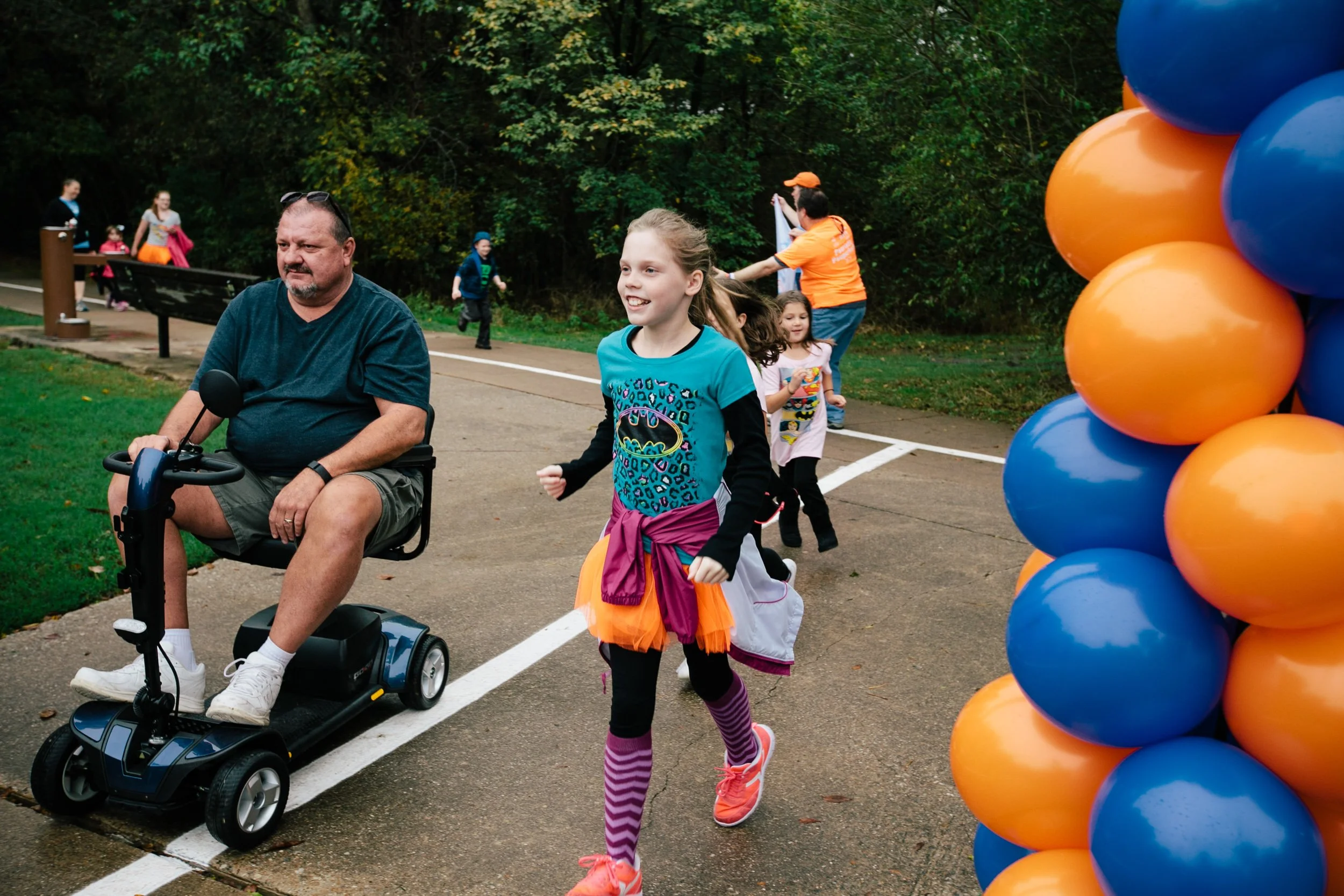 Participants move through the fundraising walk course together, showing the inclusive and family-oriented atmosphere of the event.