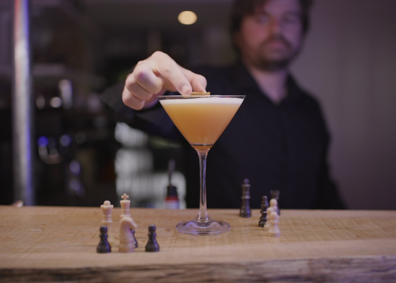 Bartender adds garnish to cocktail at Norwich board games cafe Slice + Dice