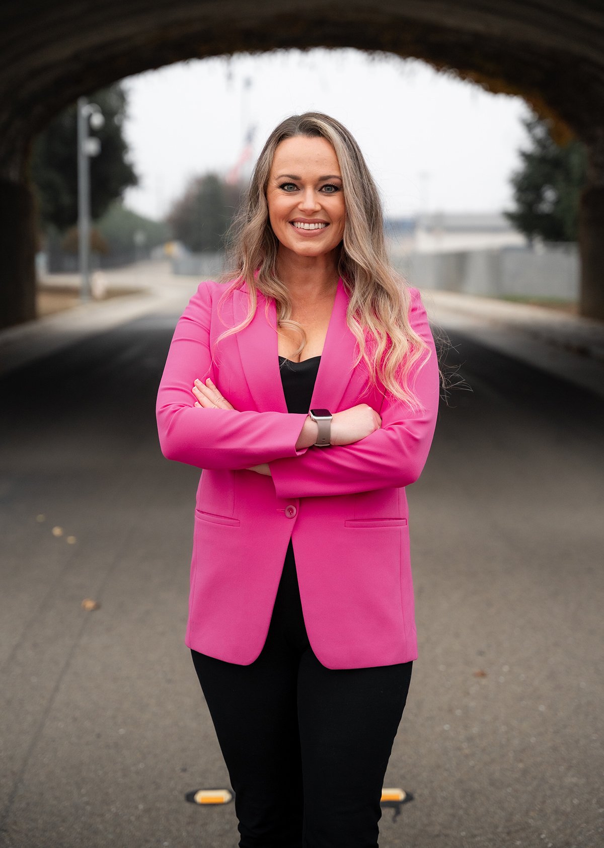 Laurie’s customers, Mariana and Carmen holding hands on a green lawn on their wedding day.