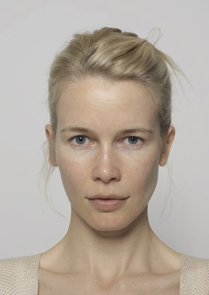 Portrait of a person with blonde hair and blue eyes, looking directly at the camera against a neutral background.