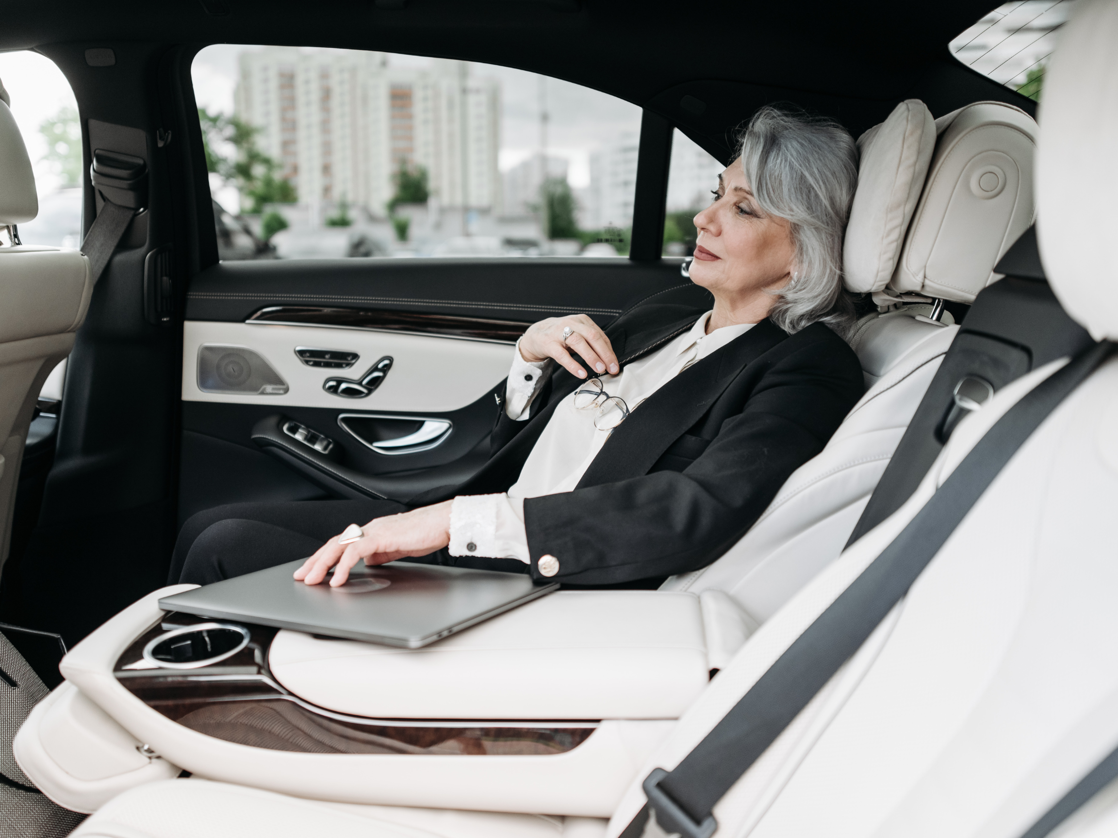 Woman in Black Suit Sitting on Car Seat
