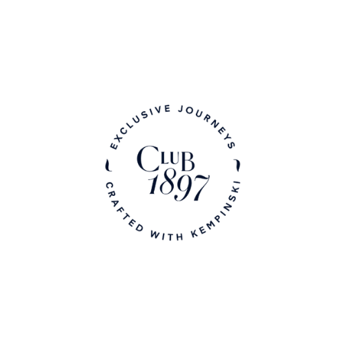 Black background with blue circular logo that says 'Exclusive Journeys' around the top, 'Crafted with Kempinski' around the bottom, and 'Club 1897' in the center.