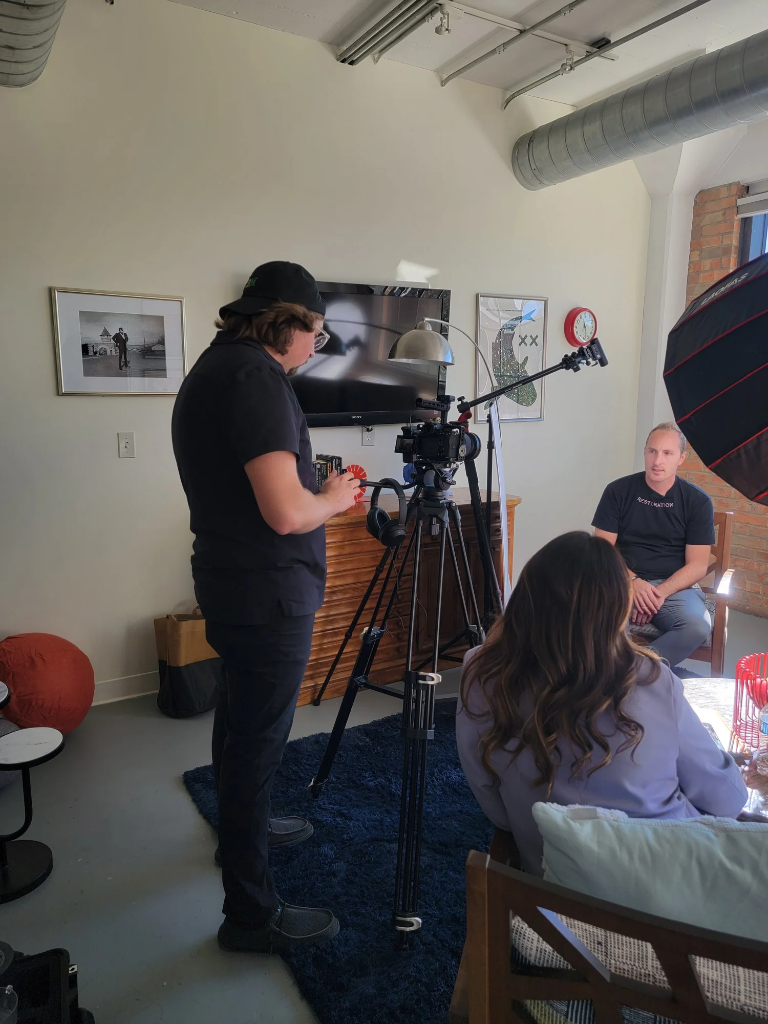 Camera operator filming an interview in an office