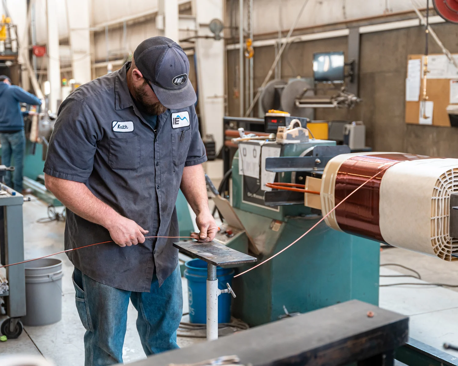 IE-Corp worker using equipment in a manufacturing facility during a corporate video and photo shoot