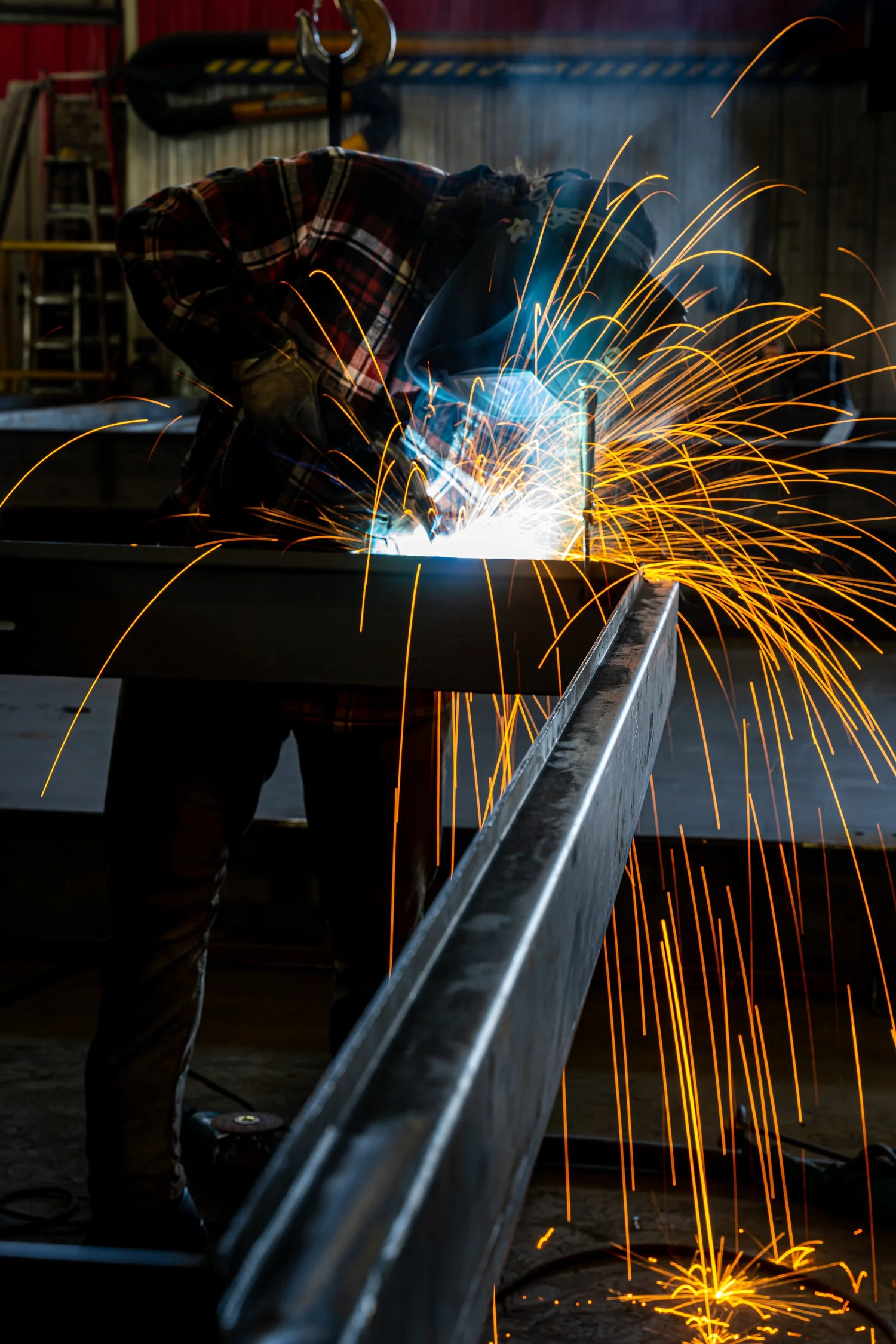 Welder at work with sparks flying, filmed for IE-Corp recruiting content