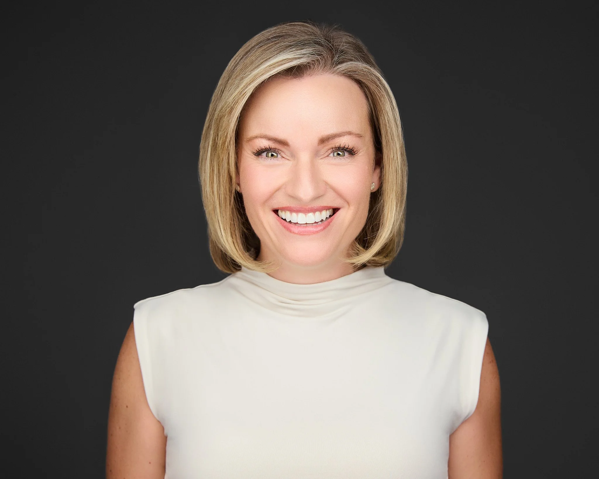 This image features a professional headshot of a business woman executive captured in a modern studio with soft lighting, highlighting their polished appearance and confident expression. The high-quality headshot represents the individual's unique st