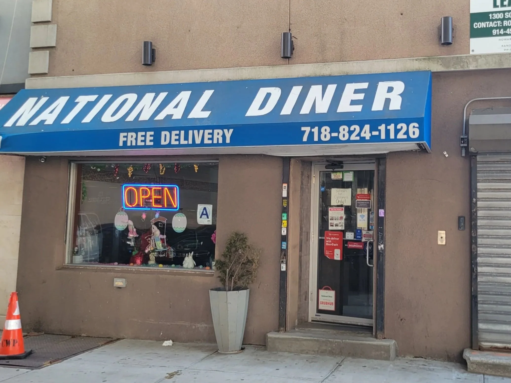 Image of National Diner restaurant store front in the Bronx, New York with man on motorcycle.