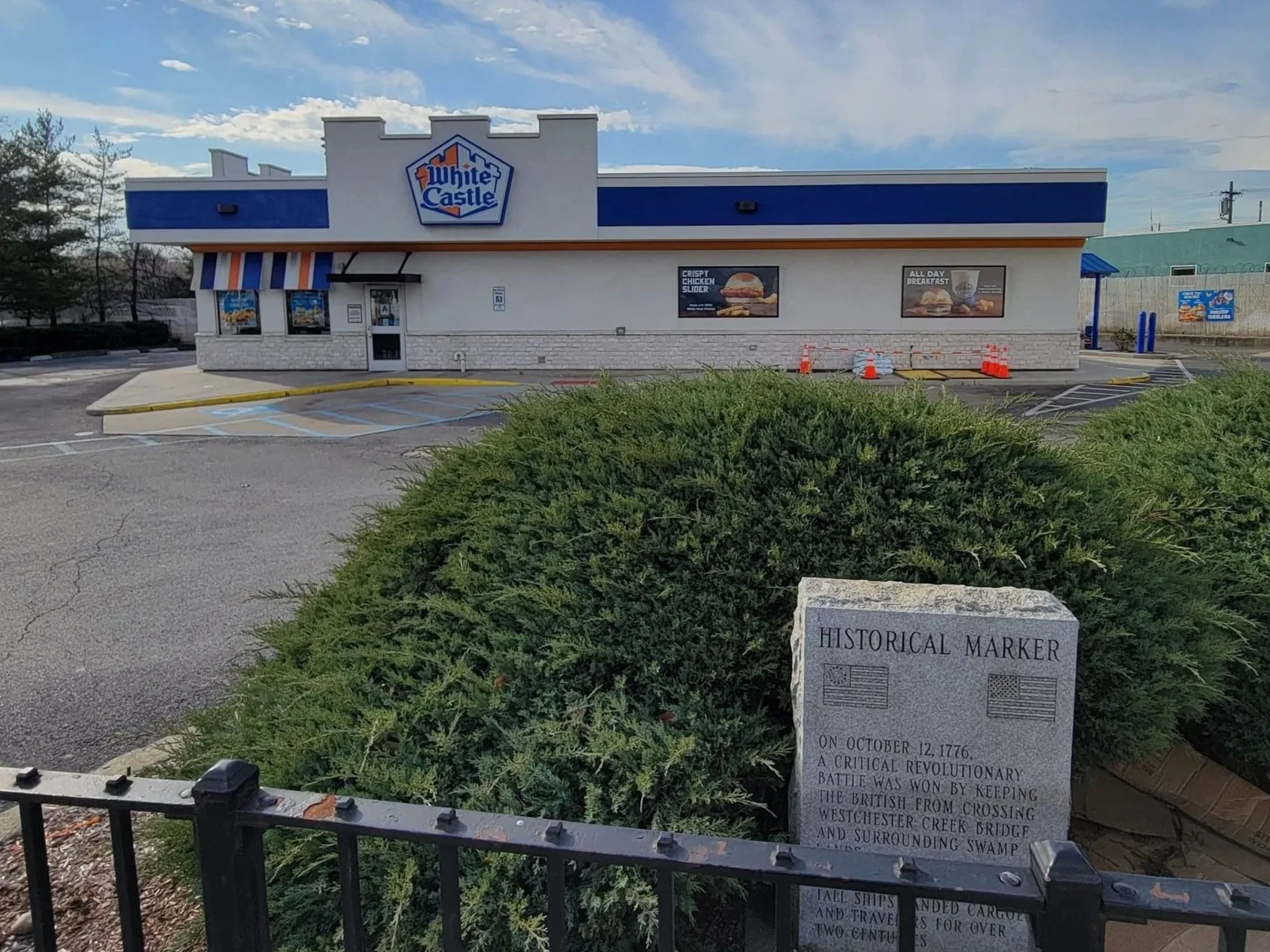 Image of White Castle fast food chain store front with car parked outside in the Bronx, New York.