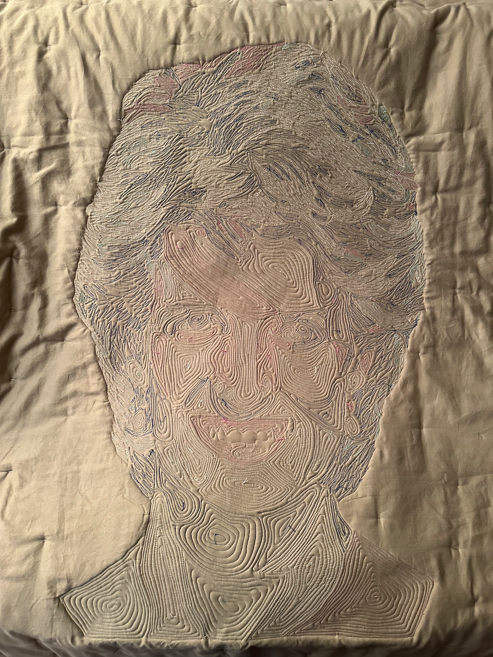 View of quilting from the back—notice the difference in quilting technique between hair and skin