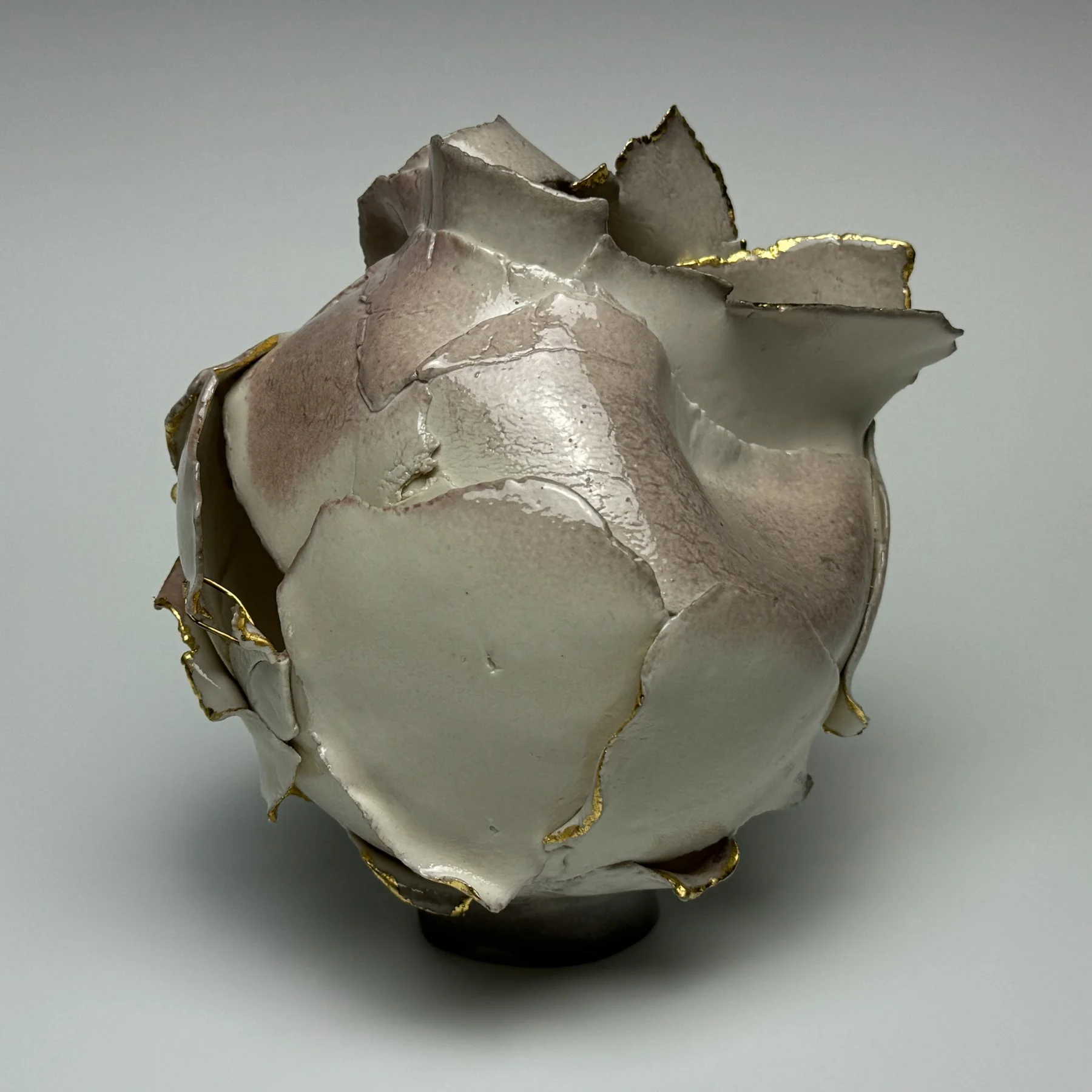 Connections Series #2	
6.5" x 6" x 7"		
Porcelain, Soda Ash Glaze, 23.75 Gold Leaf, Hand Hammered Brass Wire Staples