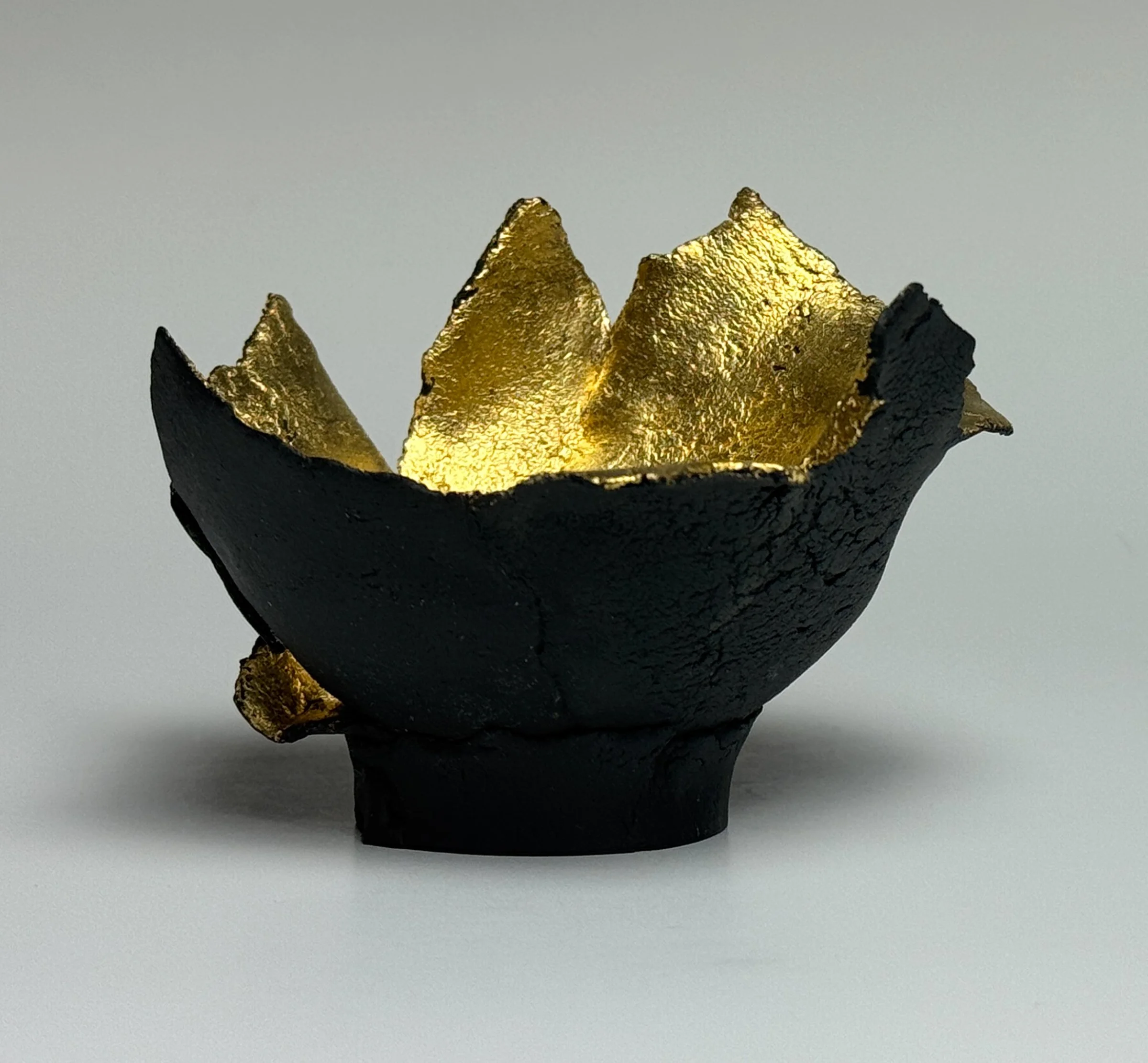 Holding, Small Works Series	
2.75" H x 4" x 4.5" 		
Custom Black Porcelain, 23.75K Gold Leaf, Cone 6, Oxidation
