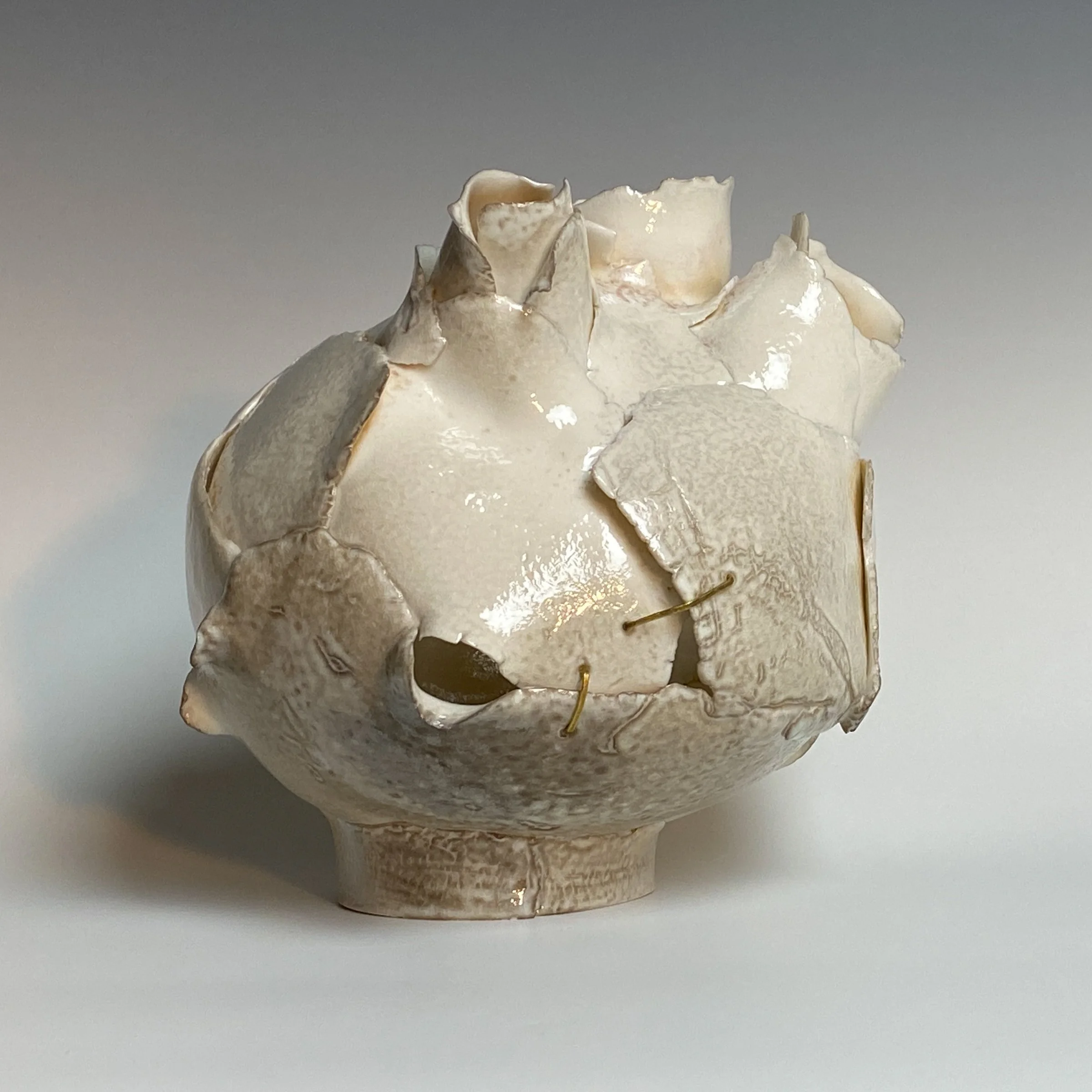 Seen, Shepherd Series #2
Porcelain, Soda/ash Glaze, Hand Hammered Brass wire, gold composite
8" x 7.25" x 7" 