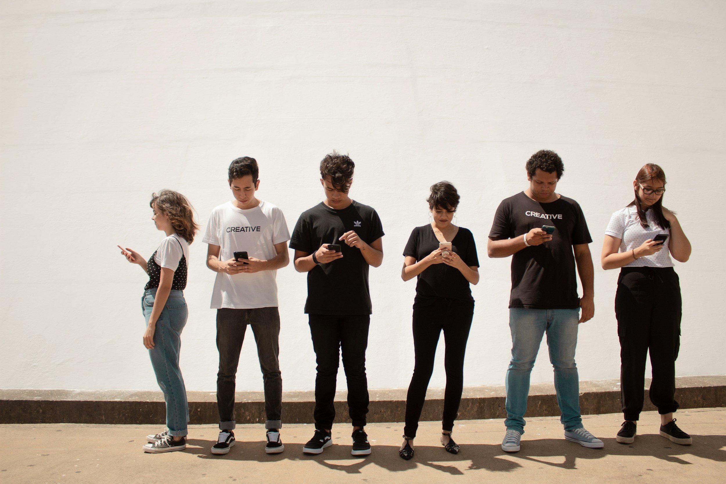 Adults standing together but disconnected, representing social communication difficulties in autism