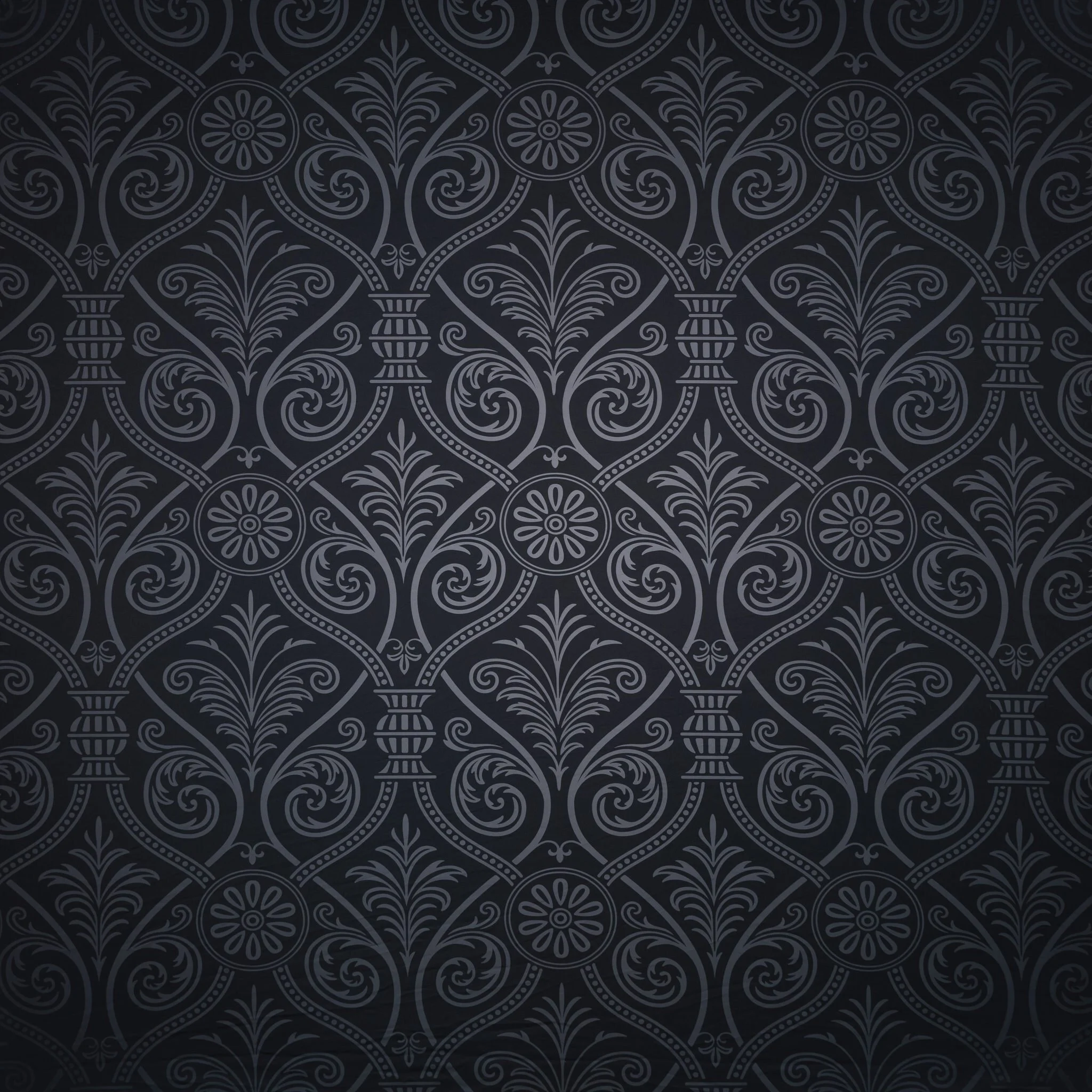 Dark decorative wallpaper with intricate floral and swirl patterns.