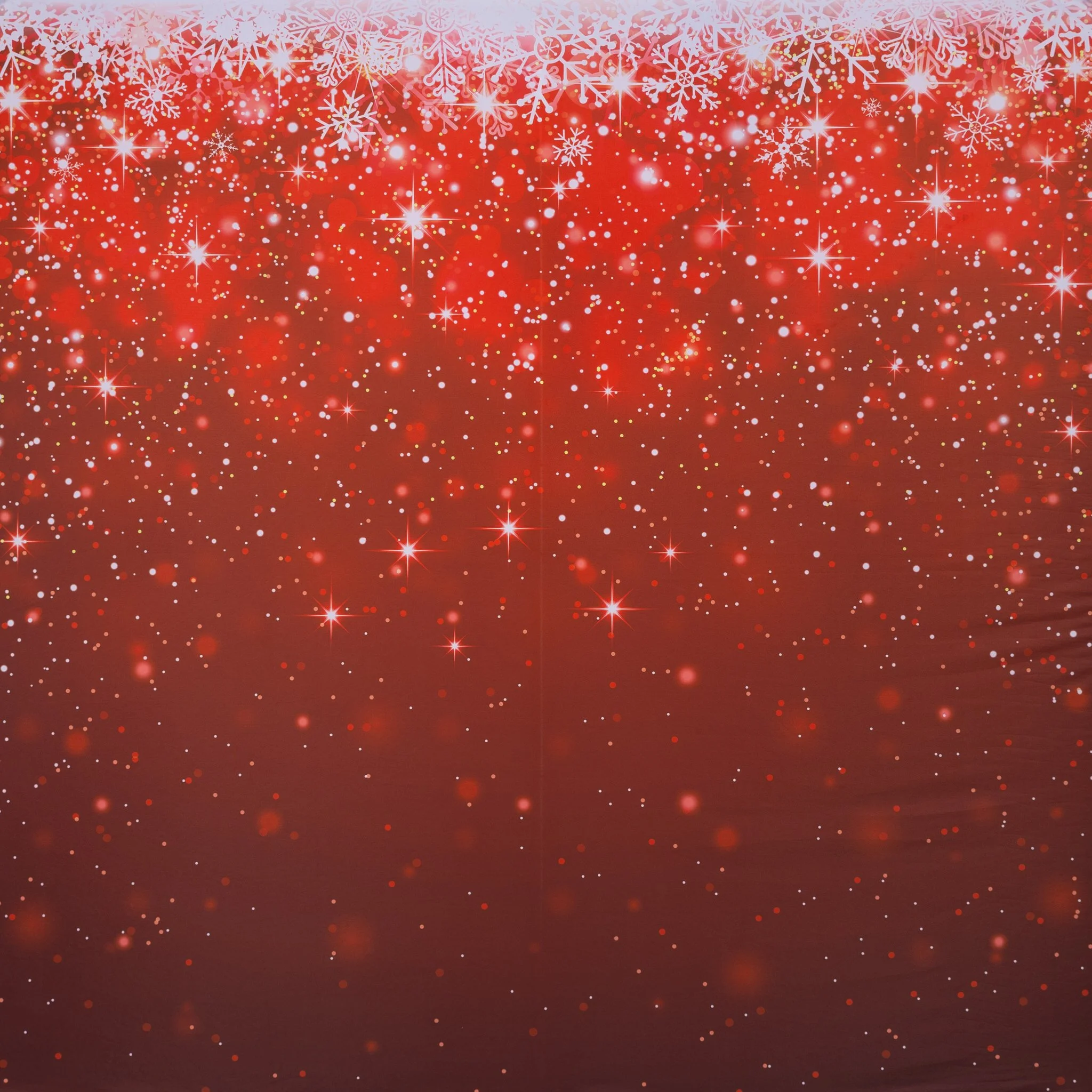 Red festive background with white snowflakes and sparkles at the top, fading into a bokeh effect with red and white dots.