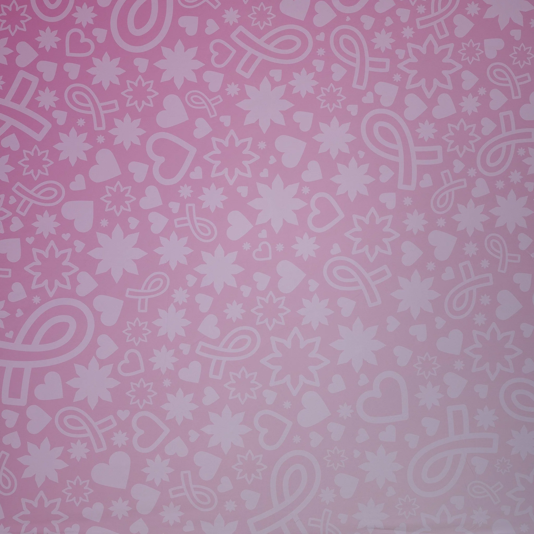 Pink background with a pattern of white hearts, stars, and ribbons.
