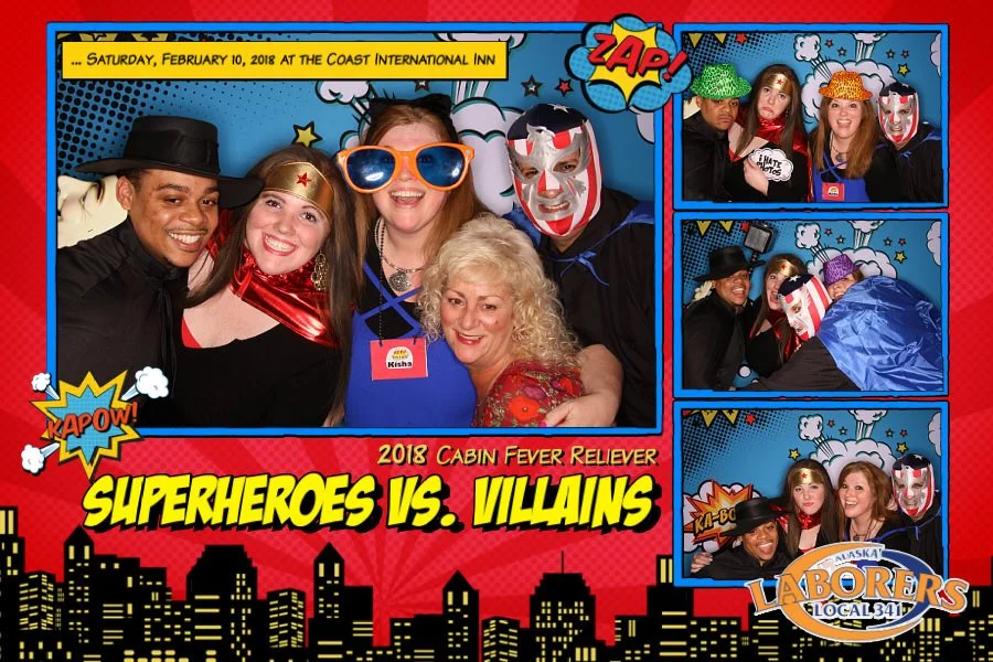 Group of five people dressed in superhero and villain costumes, posing for photos at a themed event called 'Superheroes vs. Villains' at the Coast International Inn. The background has comic book style graphics with words like 'Zap,' 'Kapow!,' and 'K