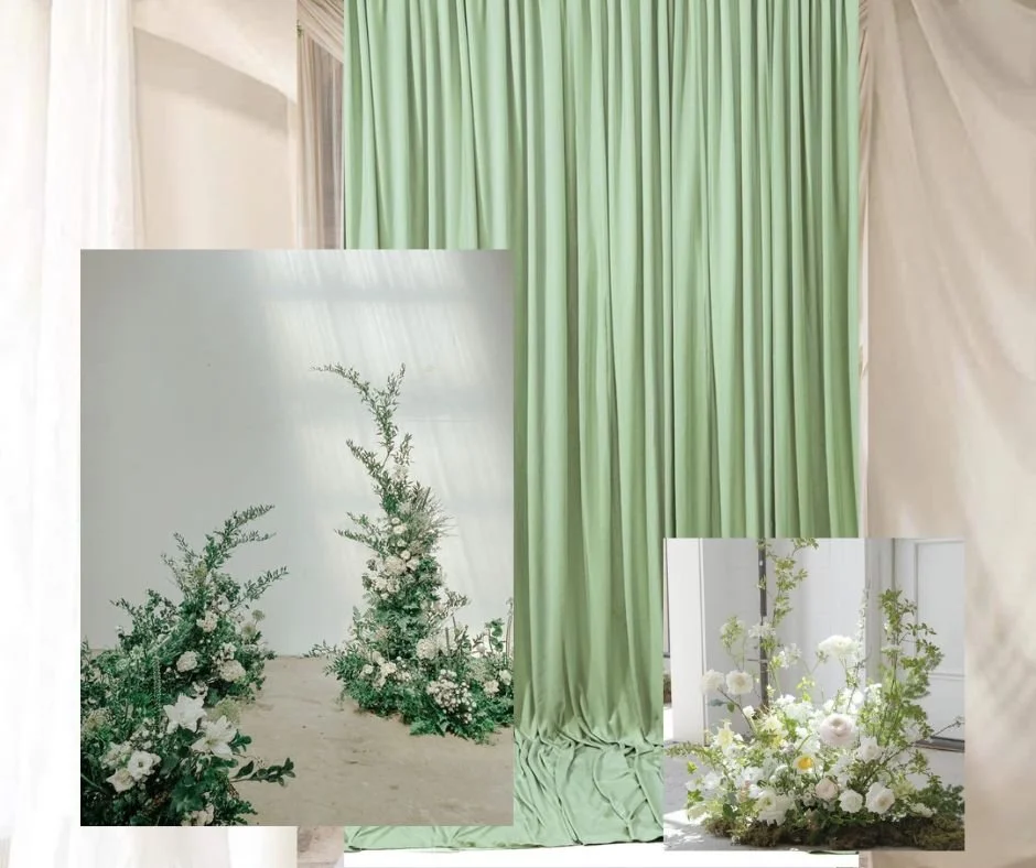 Decorative floral arrangements with white flowers and greenery against a backdrop of green and white curtains.