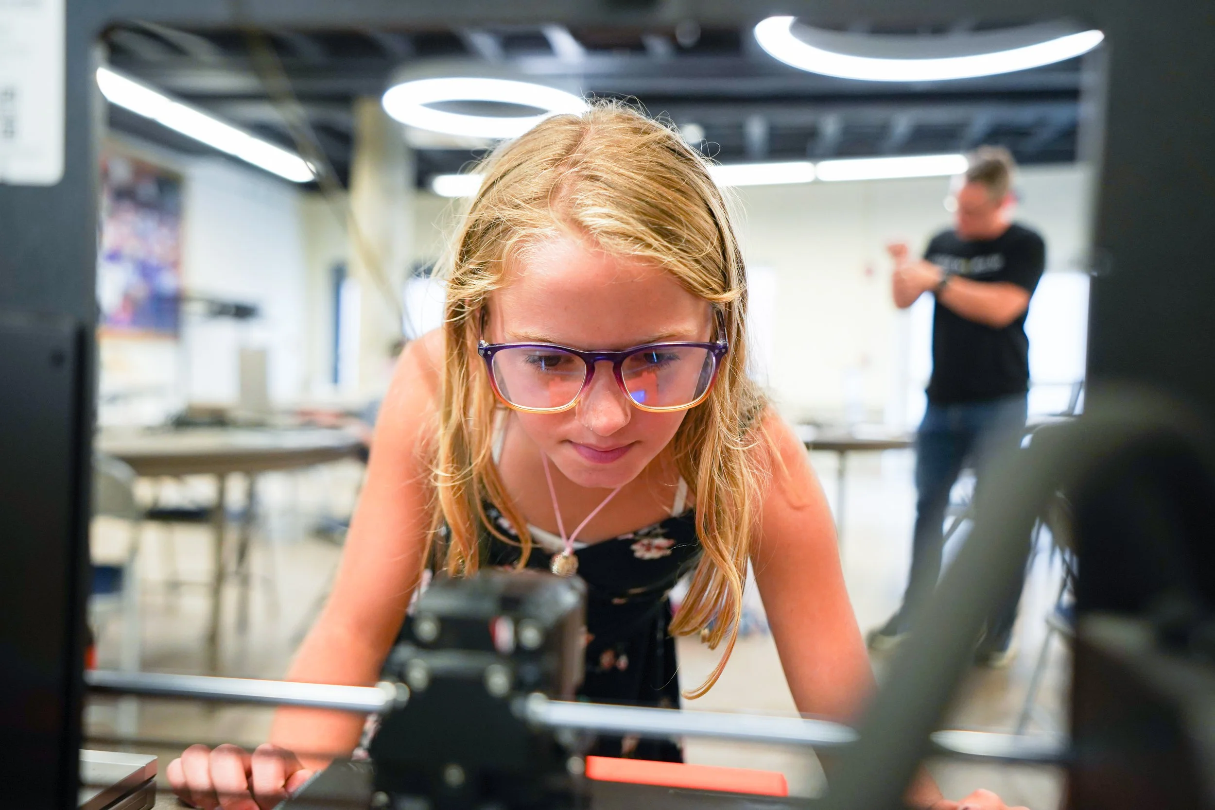 Student overlooking 3D printing process