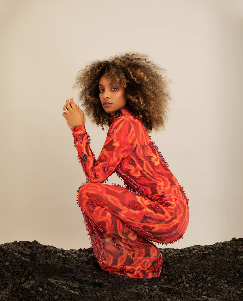 Model crouched down wearing Onalaja maxi dress