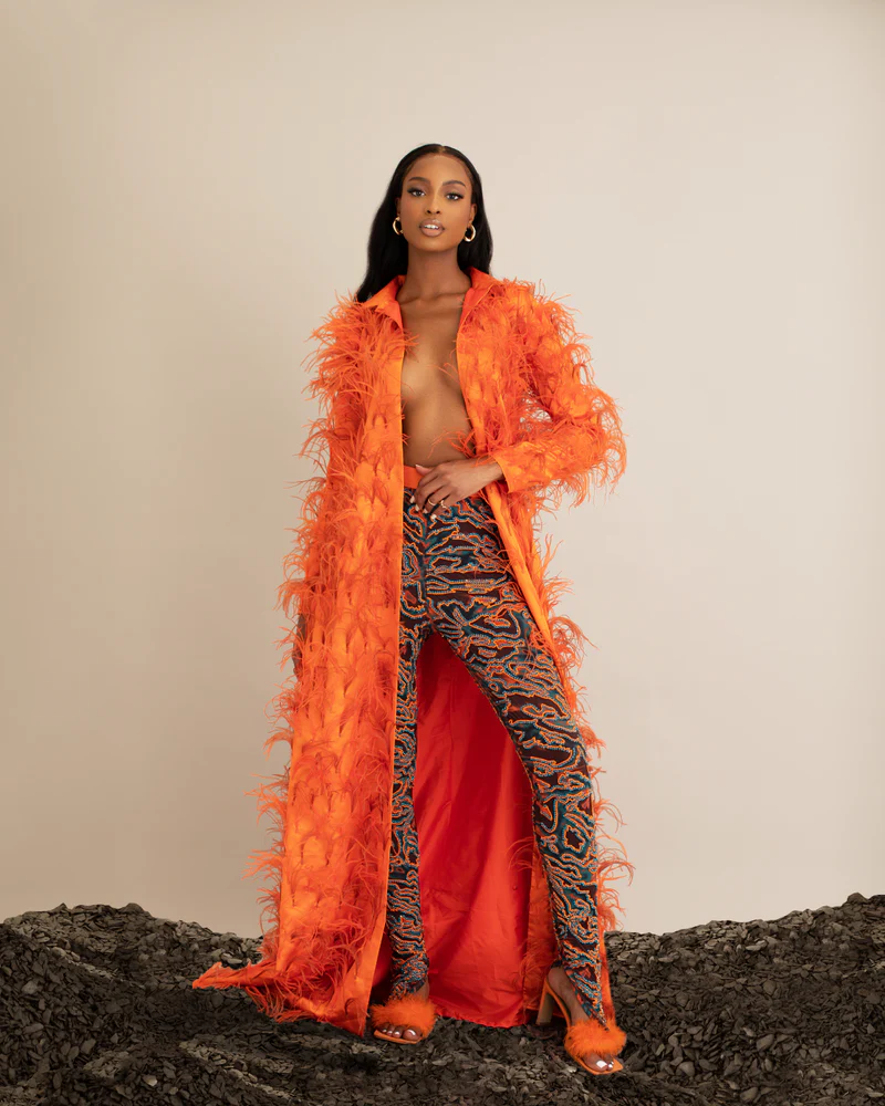 Model wearing Onalaja furry trench coat with gem stone leggings