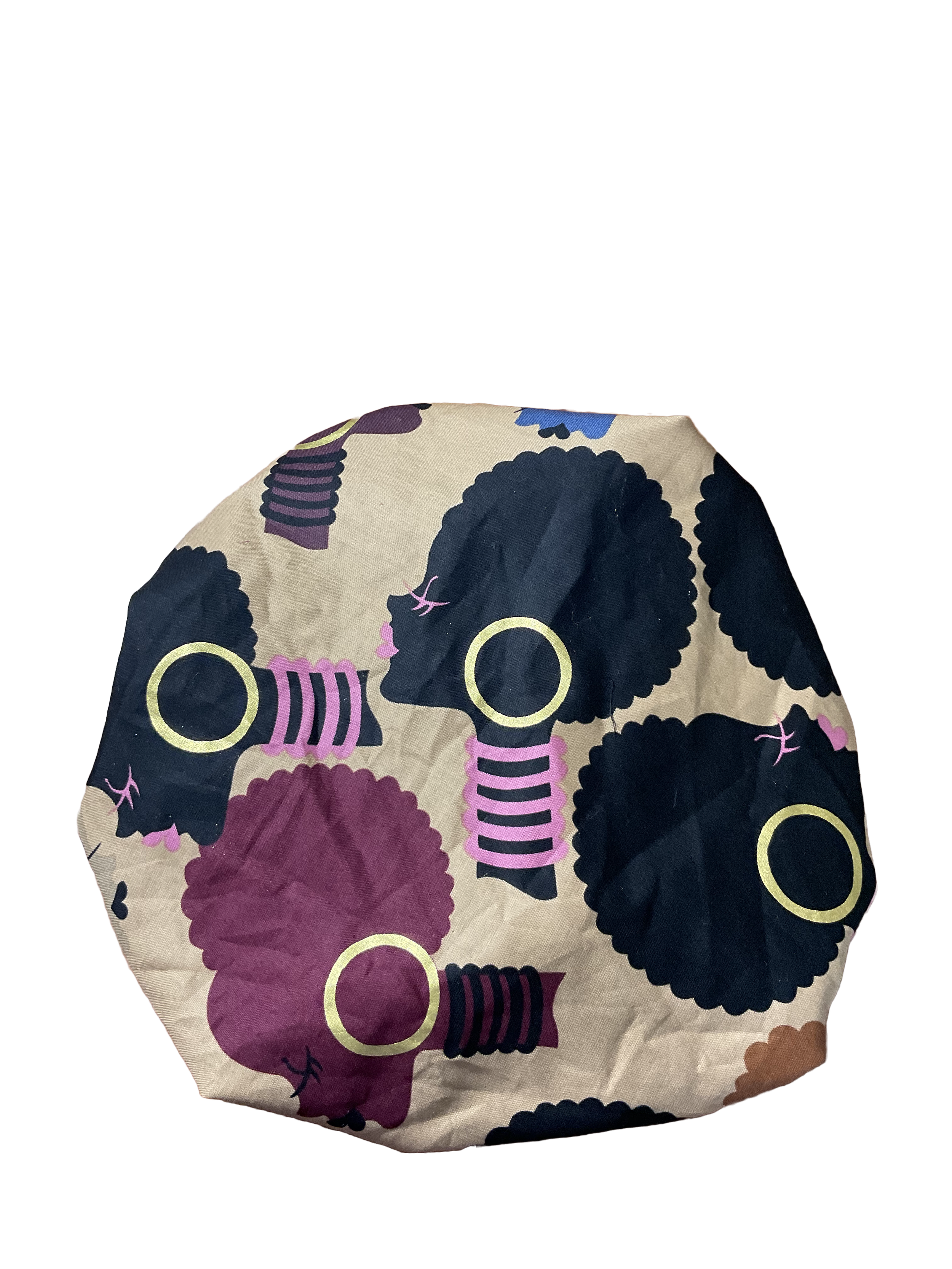 A cloth with a pattern of black, purple, yellow, pink, blue, and brown stylized women's heads with afros, large earrings, and jewelry.