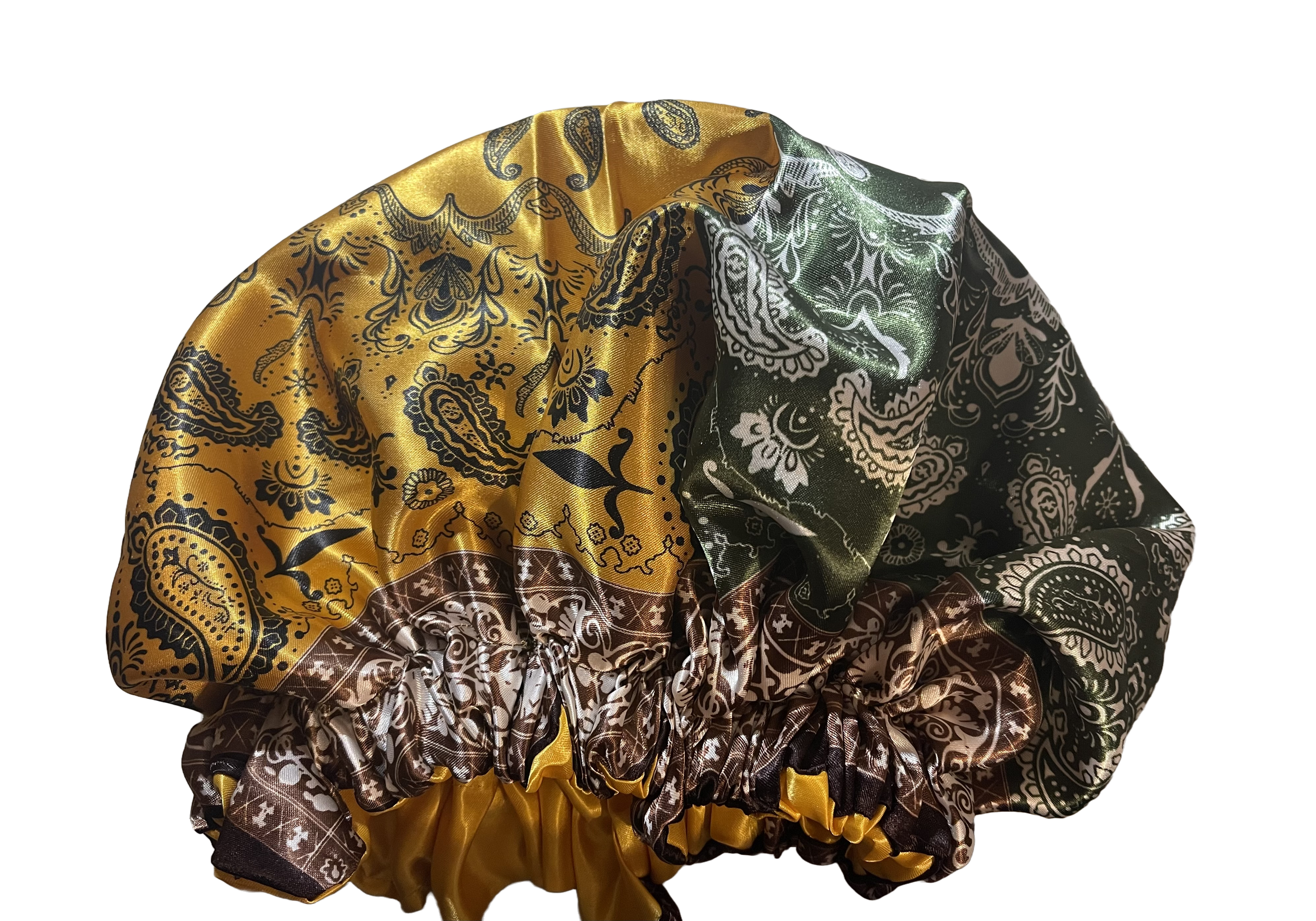 A silk scrunchie made from paisley-patterned fabric in yellow, green, and brown colors.