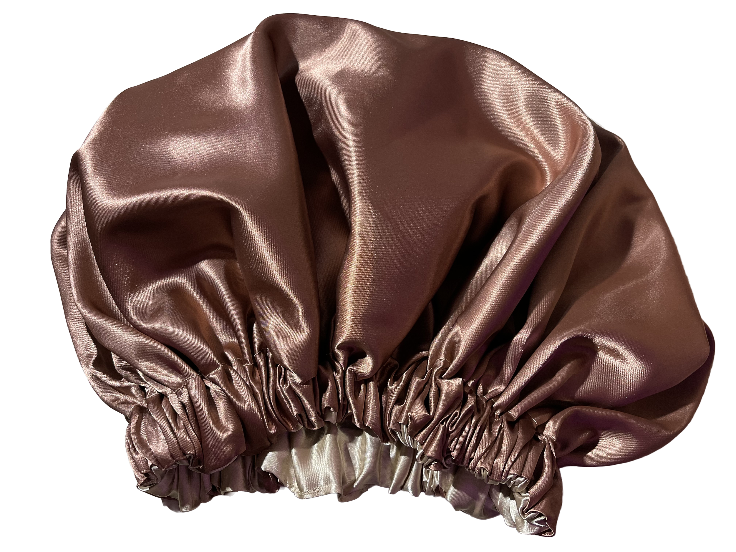 A satin bonnet in a metallic rose gold color with a gathered elastic band at the bottom.