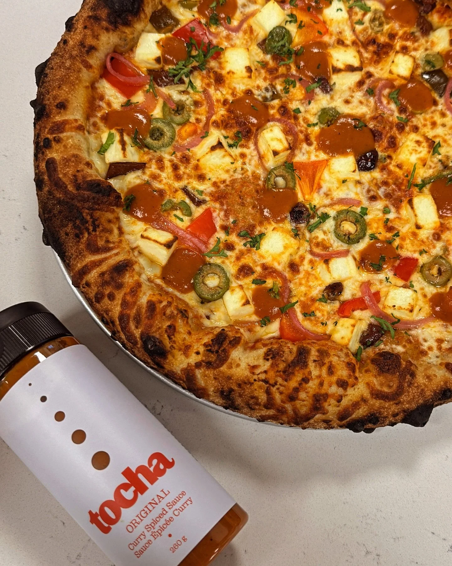 Something special just dropped at MOD Kitchen, the TOCHA Paneer Pizza. 🍕 

Built on @bakedcolumbiapizza sourdough crust and finished with @tochafoods award-winning Tocha Original sauce, it brings gentle spice, soft paneer, and a cozy, comforting Ind