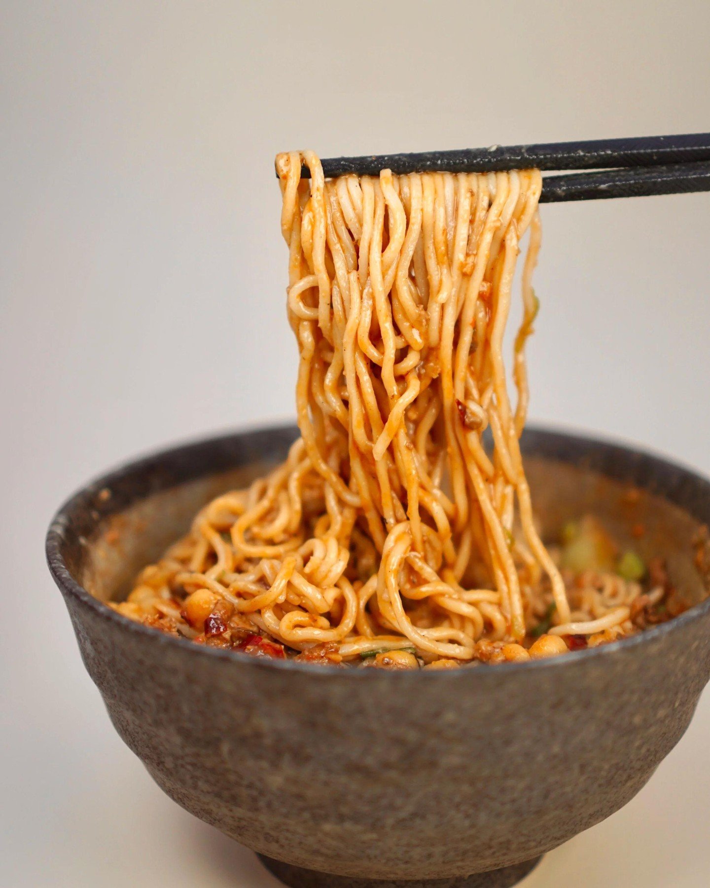 Some things take years to get right.

Chef John spent a long time chasing the exact flavour he remembered &mdash; the kind that hits you before the bowl even reaches the table. Spicy, numbing, layered. The kind of noodle that makes you stop mid-bite 