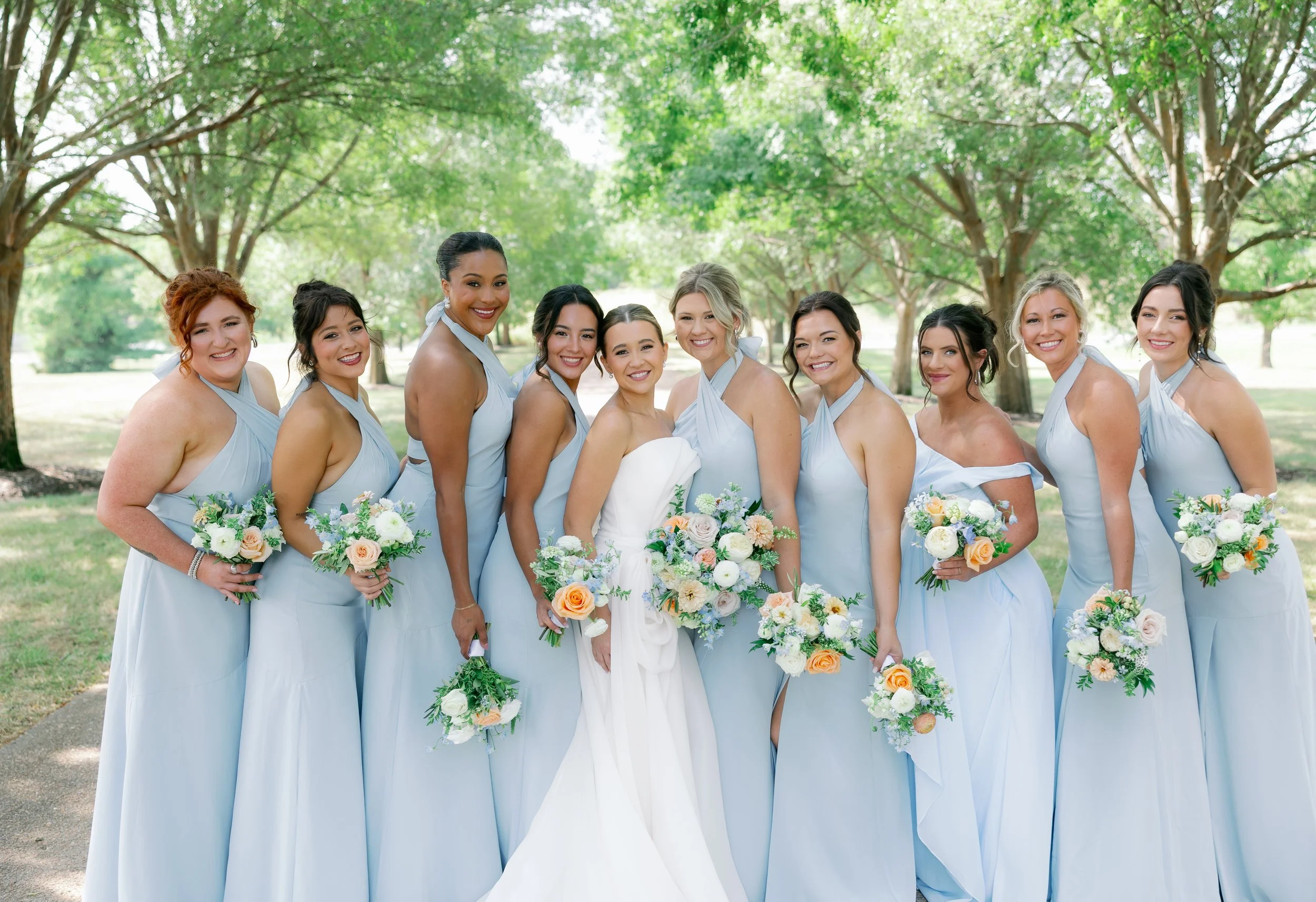 Coordinated bridesmaid florals featuring loose, airy blooms for a romantic summer wedding at The Callaway Jewel.