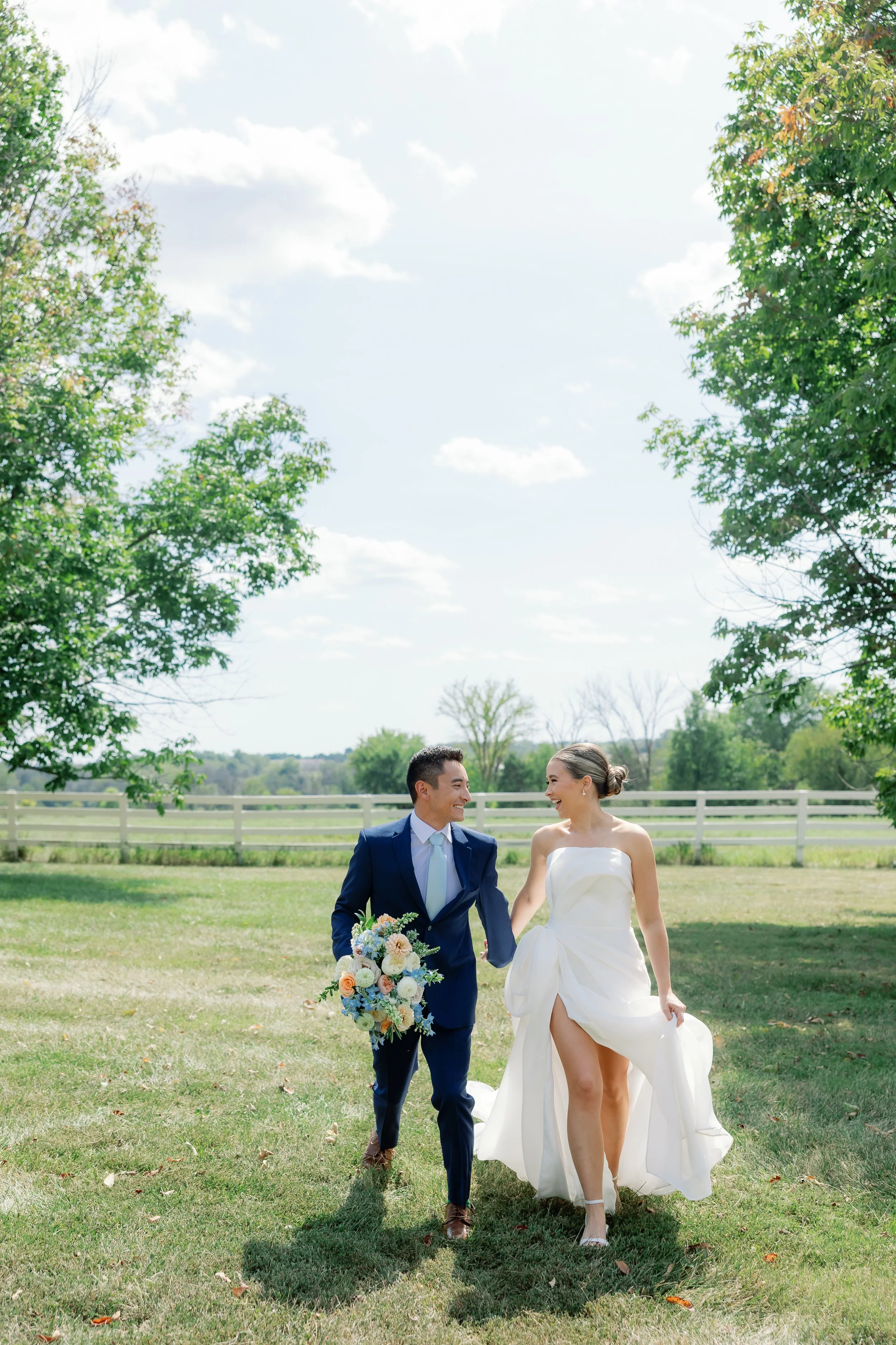 Callie and Austin share a joyful newlywed moment, surrounded by the soft pastel colors and warm summer light that defined their wedding day.