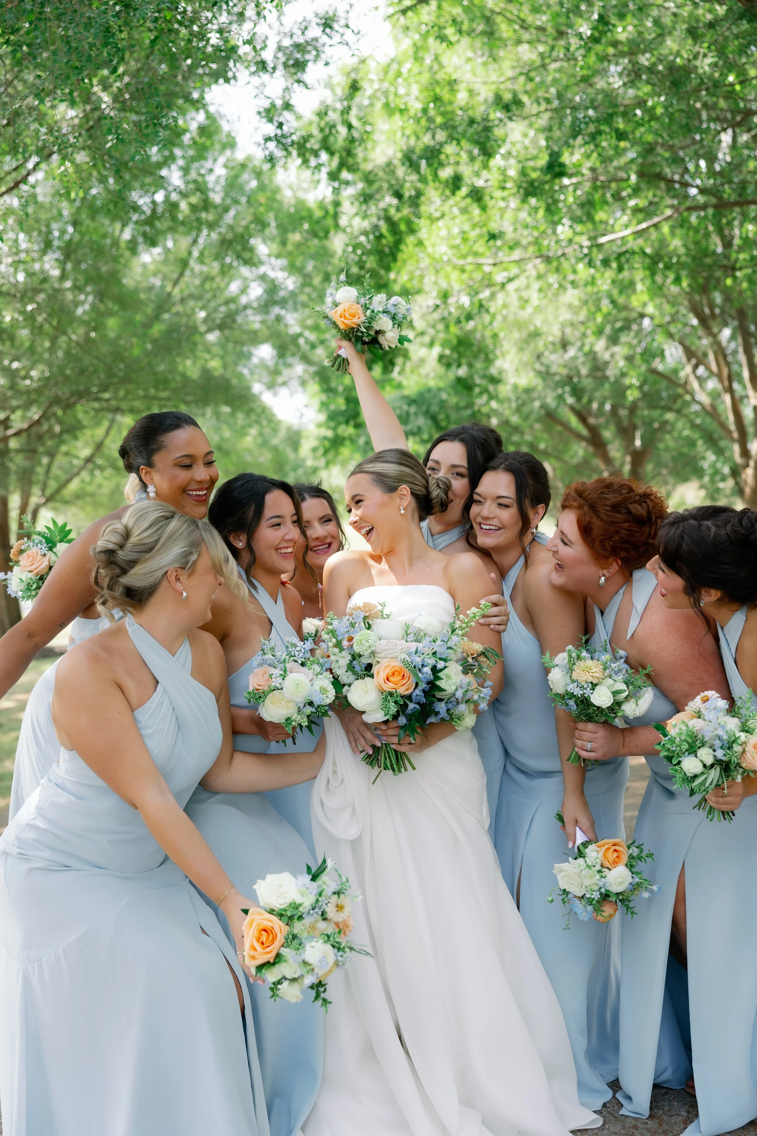 Missouri bridesmaid bouquet inspiration in soft blue and peach tones for outdoor summer weddings.