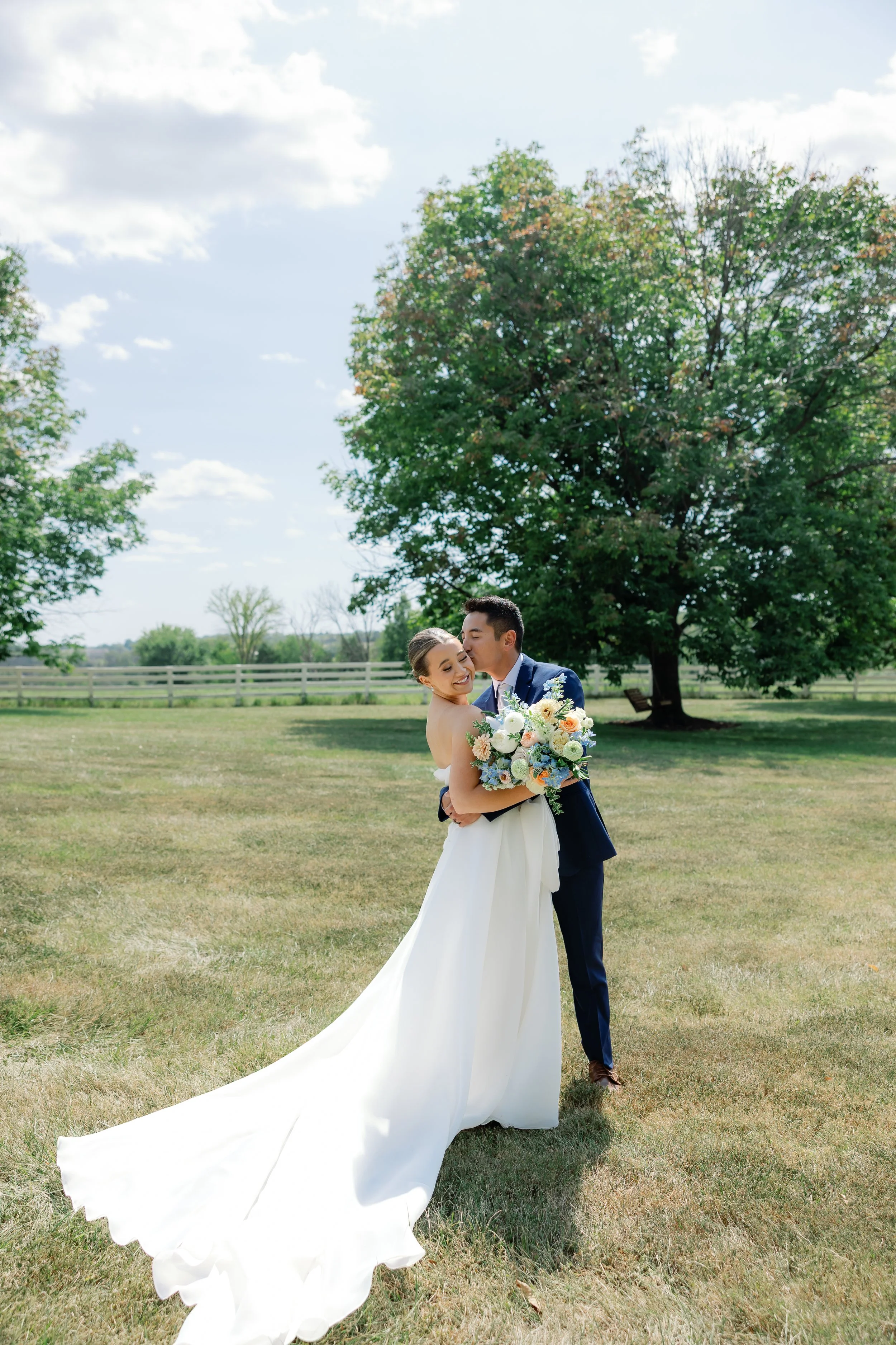 Callie and Austin pause for a beautiful photograph, documented by Jennifer Wahlbrink Photos and styled with delicate pastel florals.
