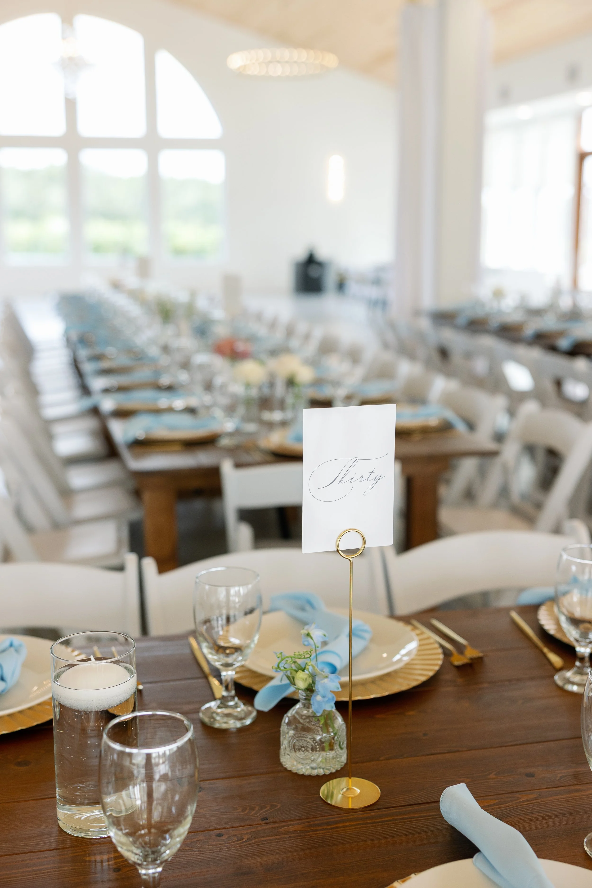 Soft summer centerpiece designs bringing warmth and refinement to Callie & Austin’s indoor reception.