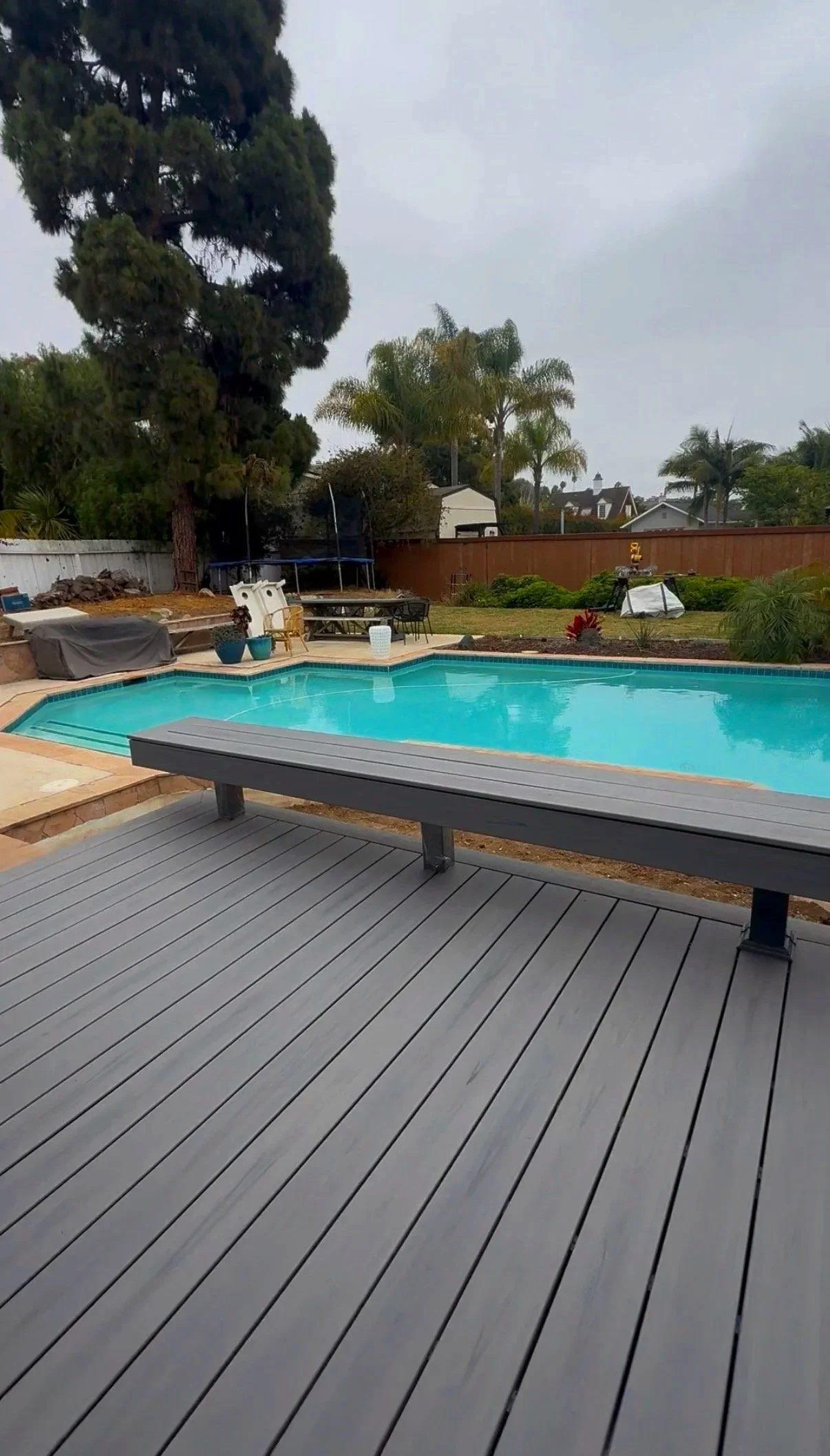 Custom Trex pool deck with build-in bench seating in Encinitas, CA