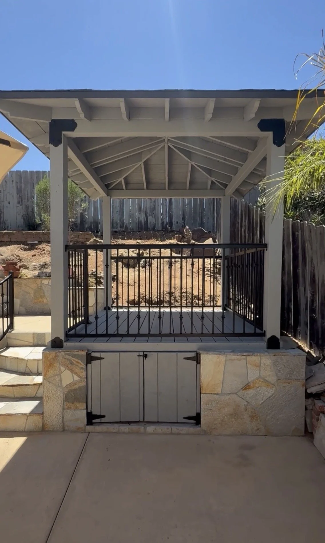 Custom wood gazebo with hip roof and iron railing in San Diego, CA.