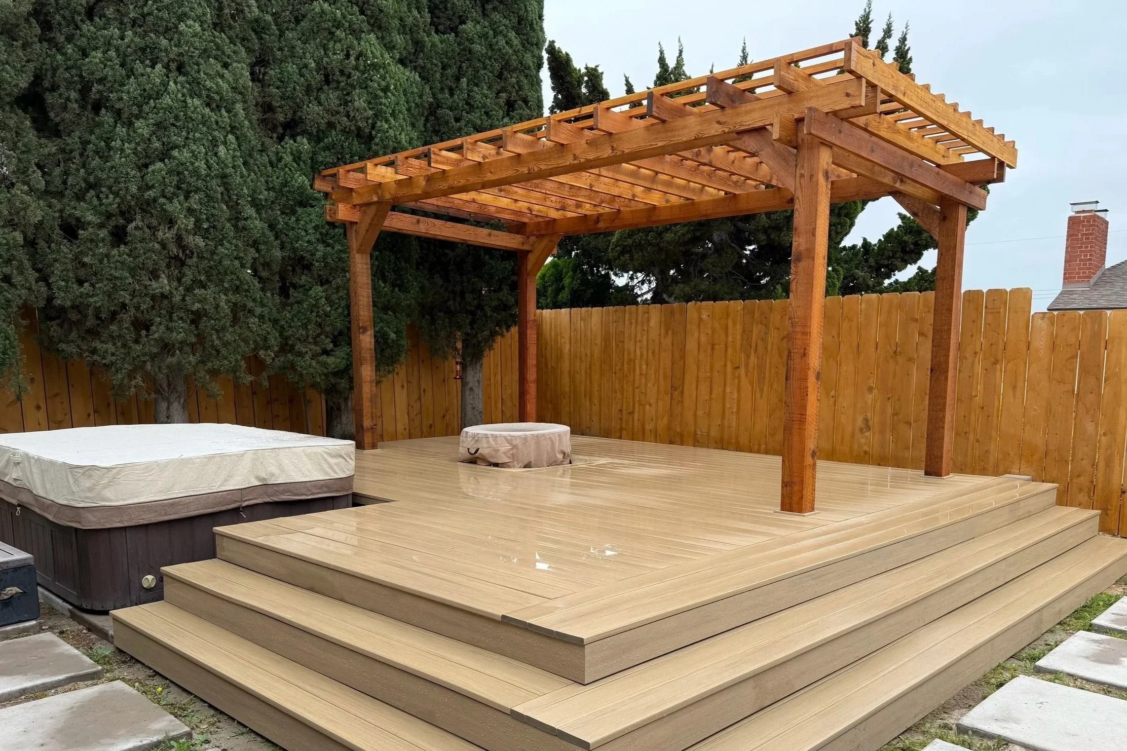 Custom composite deck with wood pergola for an outdoor living space in La Mesa, CA.